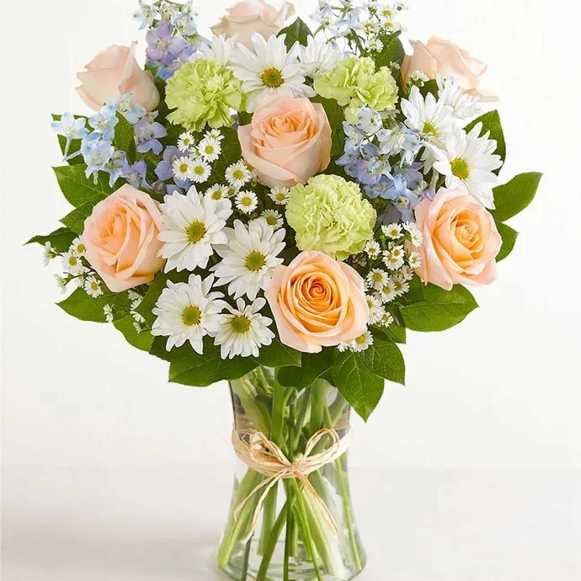 All-around arrangement with peach roses, blue delphiniums, lime-green carnations, and white daisy