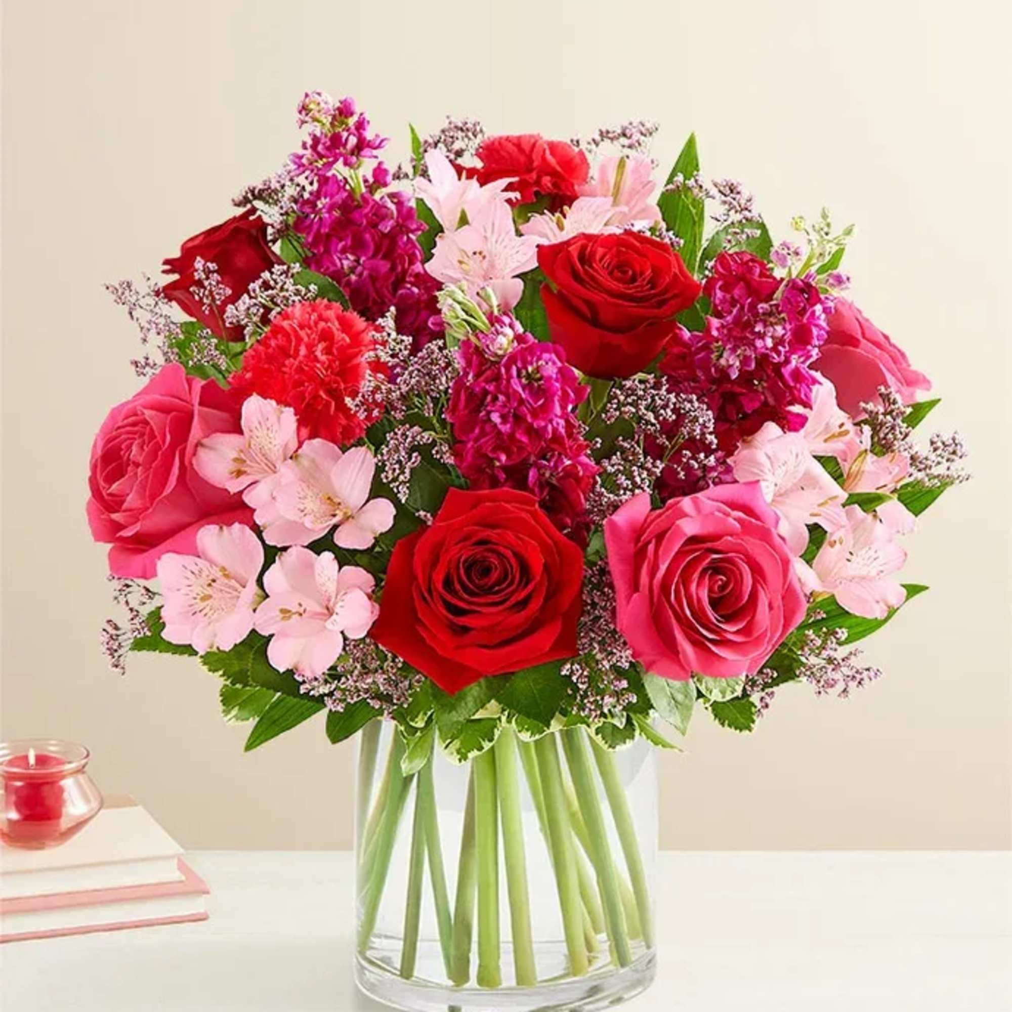All-around arrangement with red roses, hot pink roses &amp; carnations, pink Peruvian