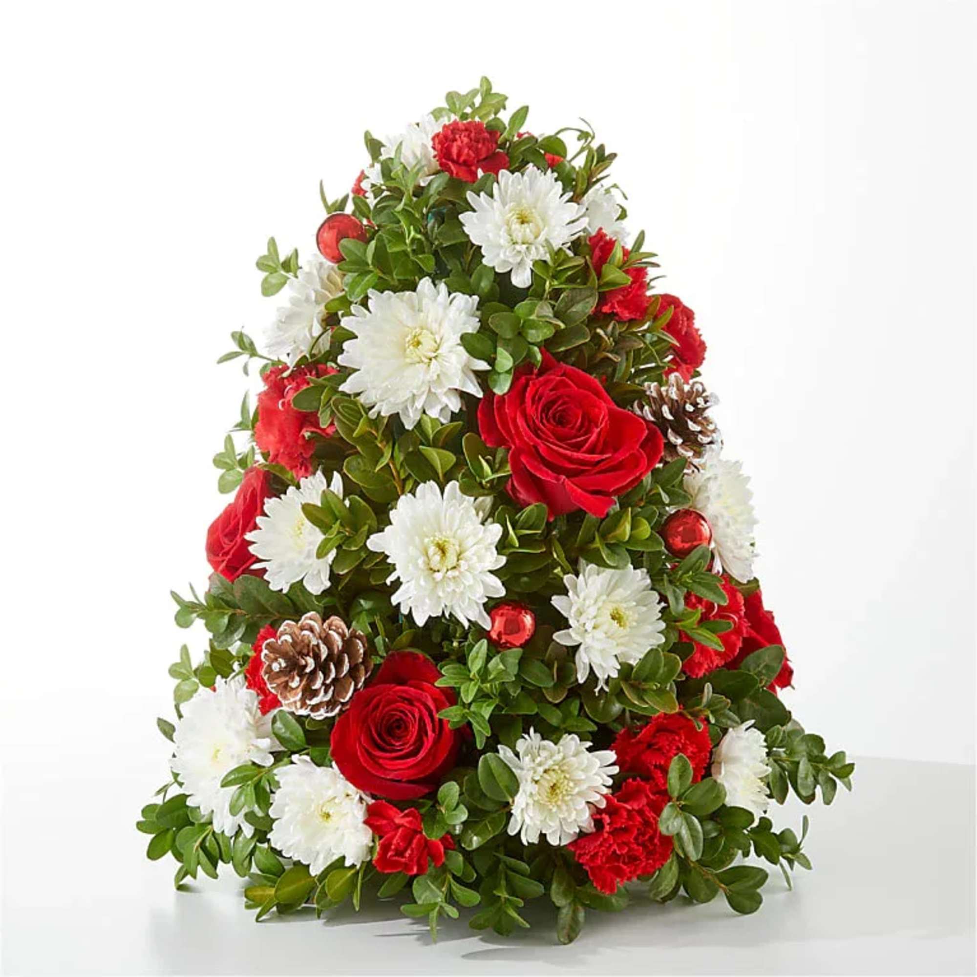 Cone-shaped floral arrangement with red roses, white daisies, and pinecones