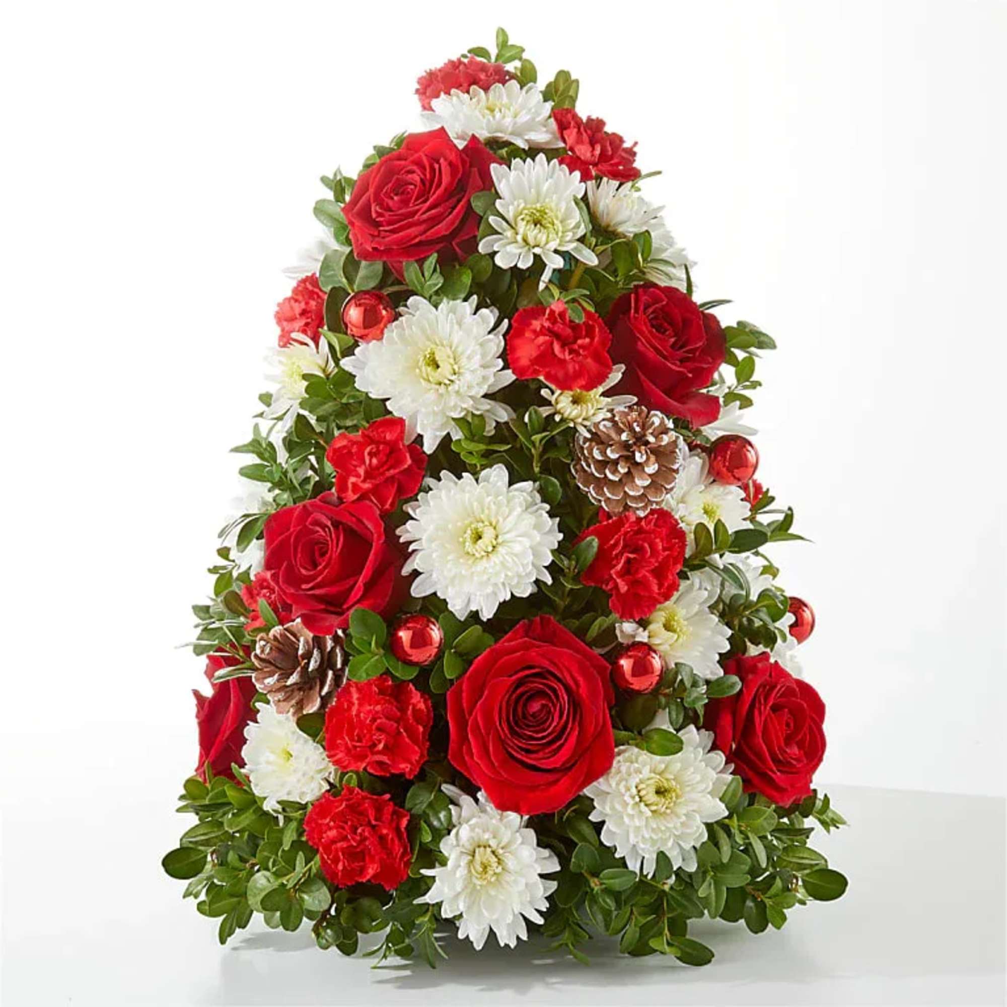 Christmas tree-shaped arrangement of red roses, white daisies, and pinecones