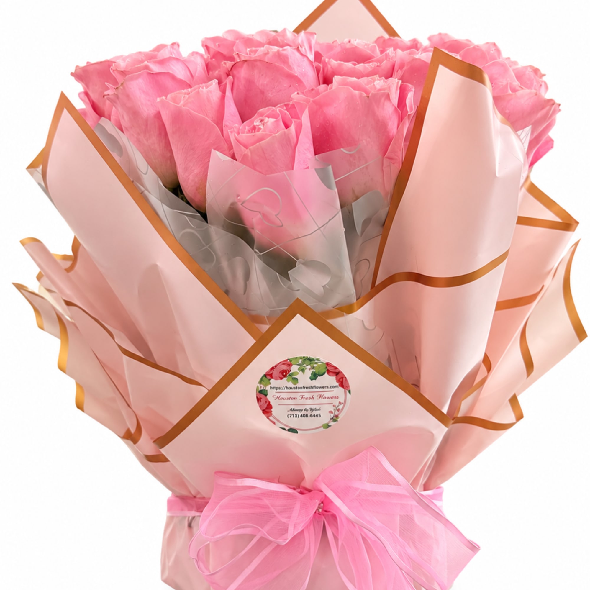Bouquet of pink roses wrapped in pale pink paper with a ribbon