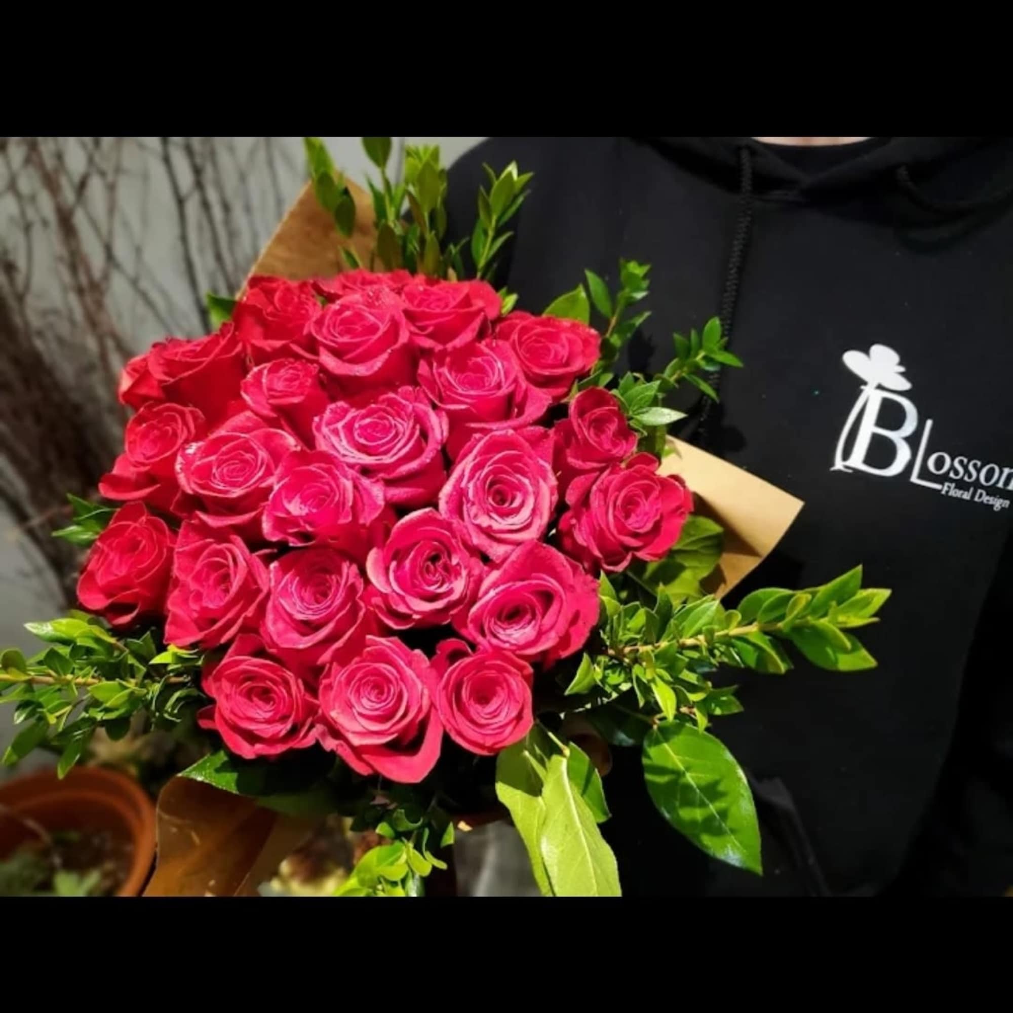 Bouquet of bright pink roses with green foliage