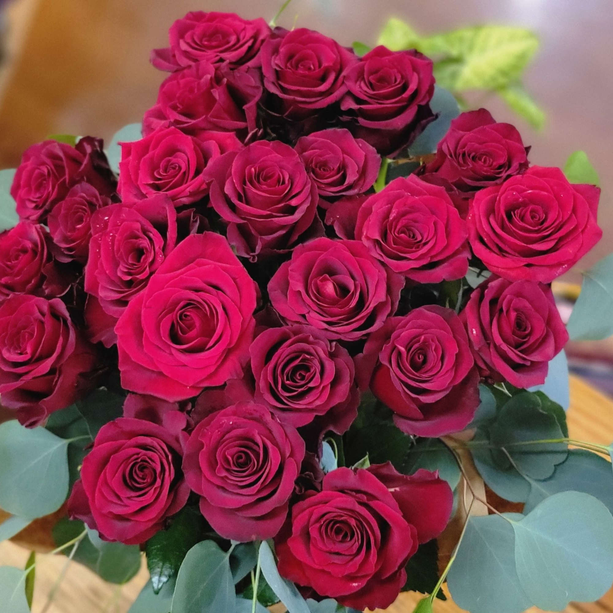 Bouquet of deep pink roses with pale blue-green foliage