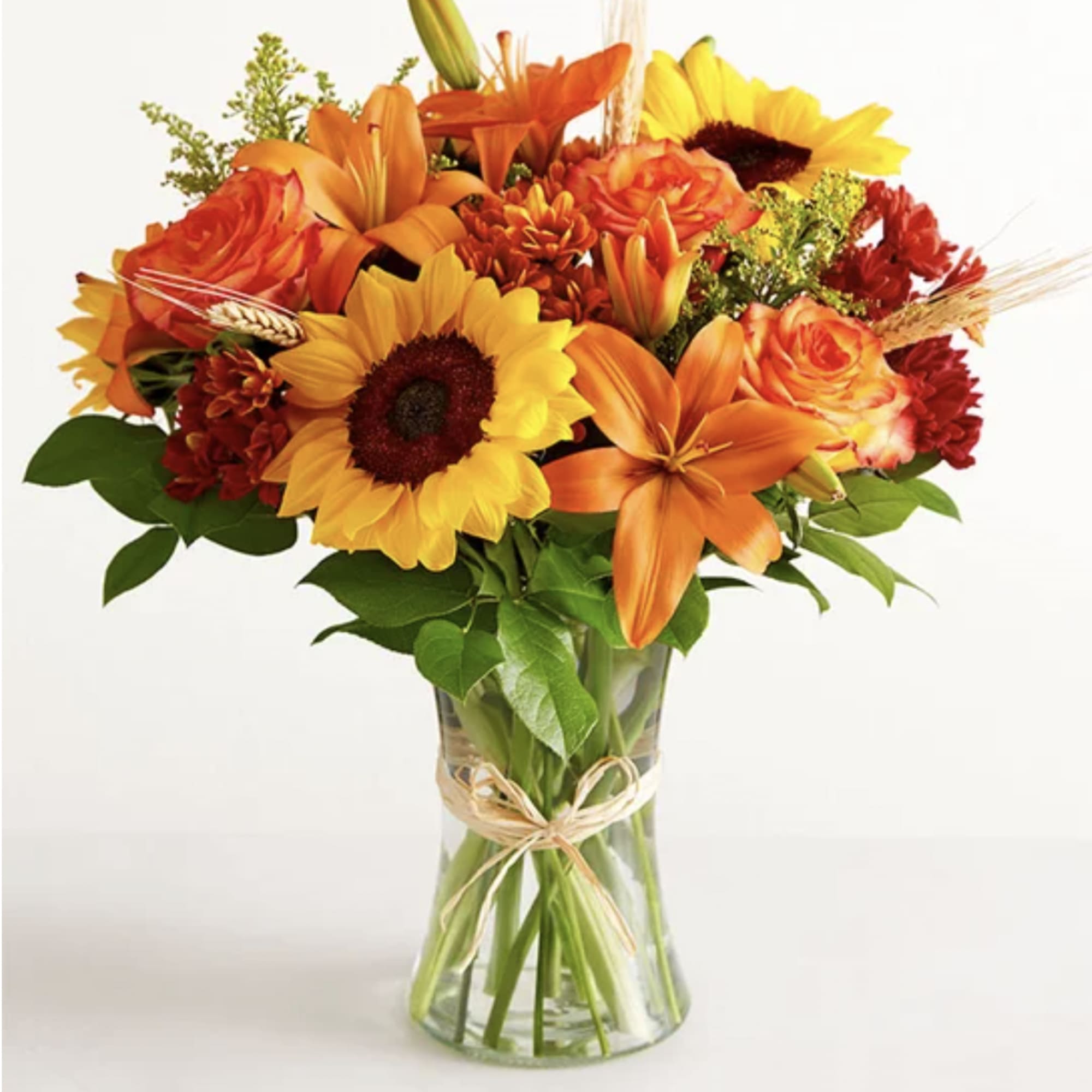 Orange and yellow mixed bouquet in a clear glass vase