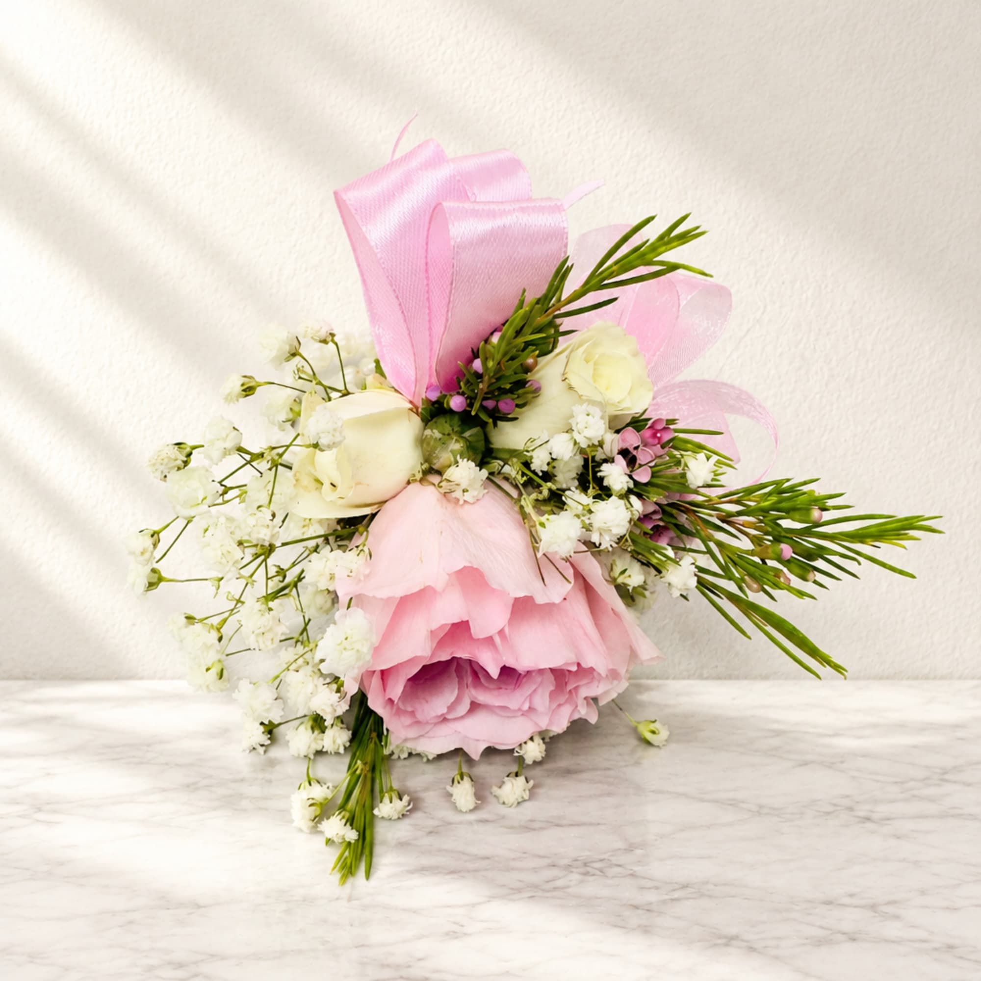 Pink and white bouquet with roses and baby's breath, tied with pink ribbon