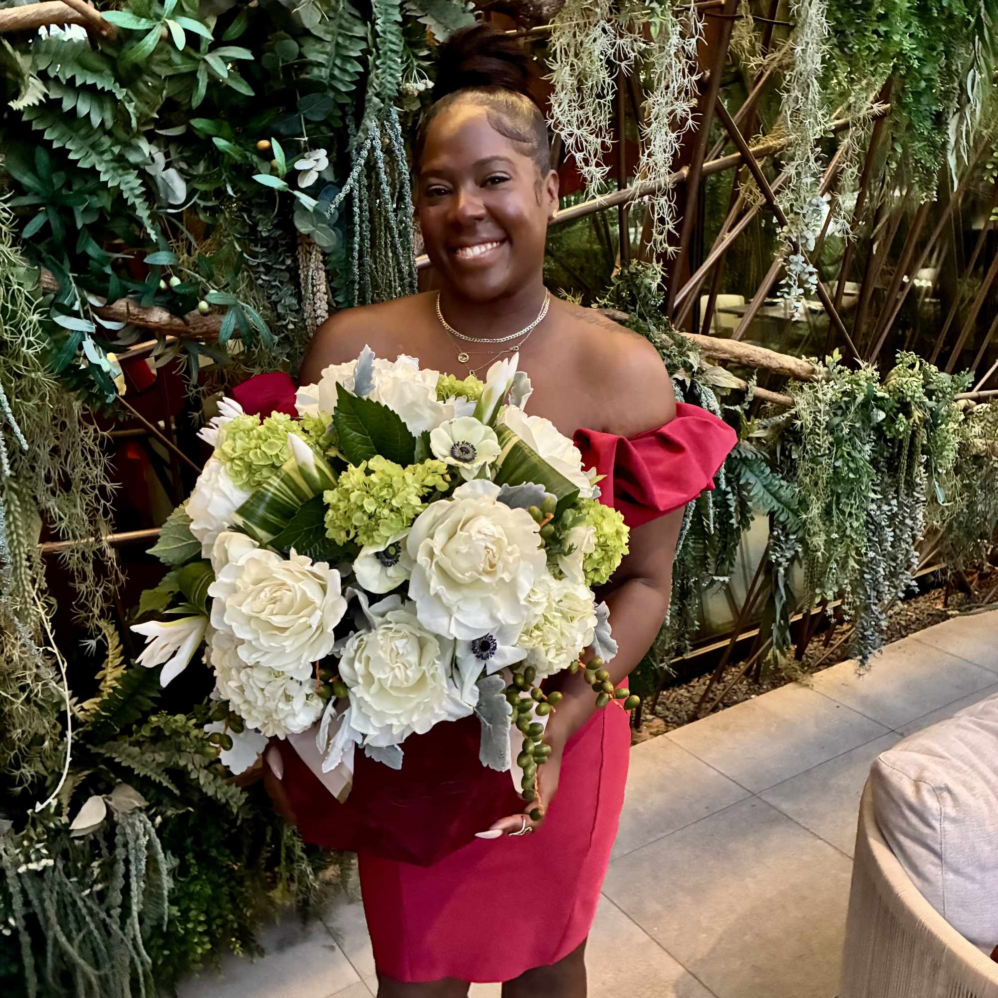 Woman holding a large white and green bouquet