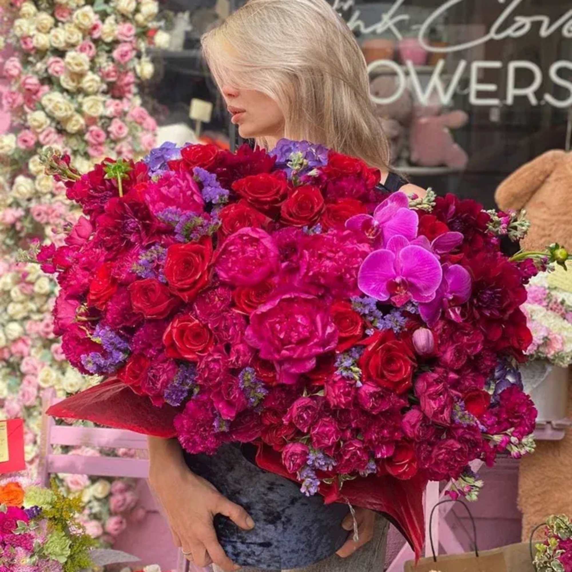 Large bouquet of red, pink, and purple flowers with orchids