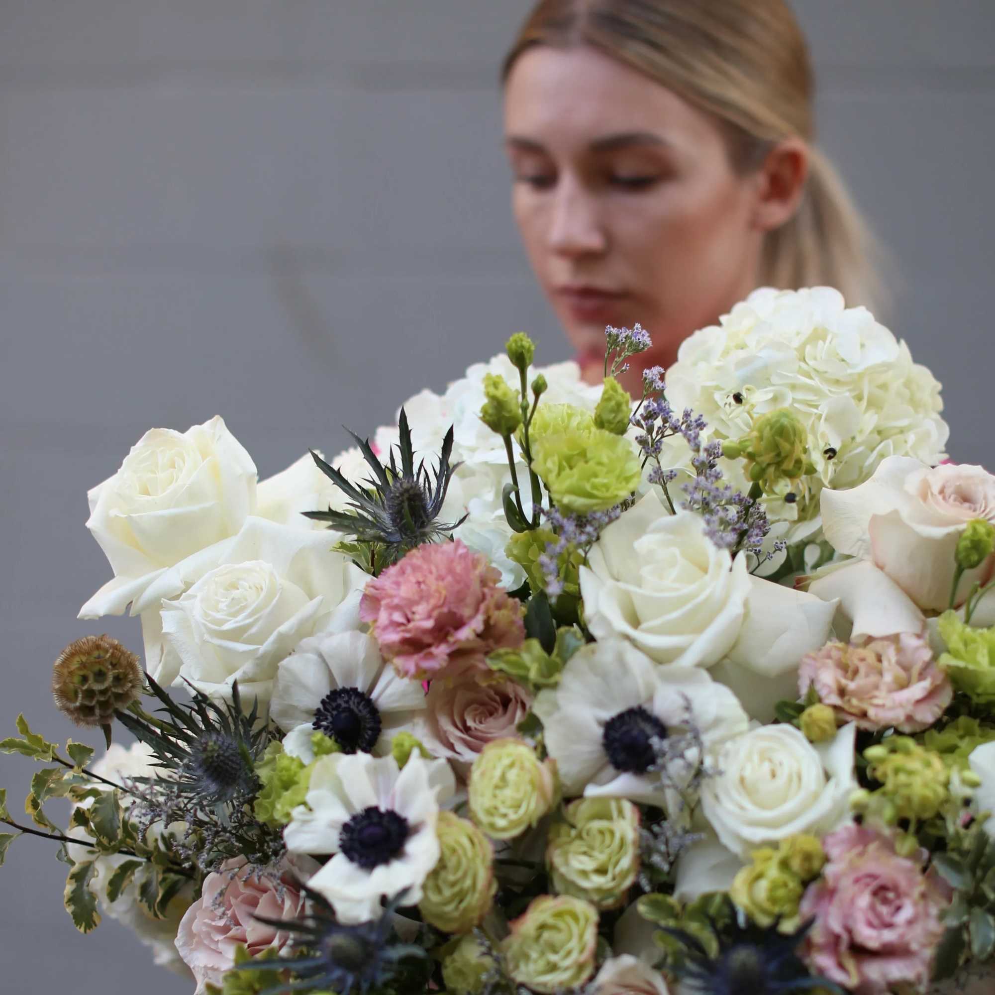 Large bouquet of white roses, hydrangeas, and mixed pastel flowers