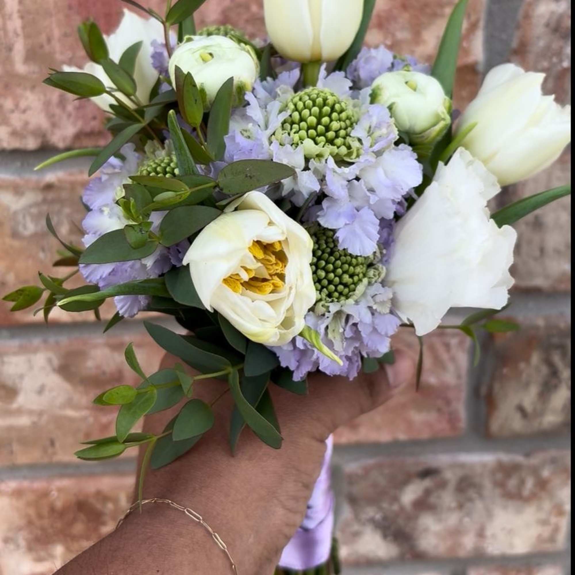 A sweet petite posey of white tulips, lavender scabiosa, lisianthus, and ranunculus.