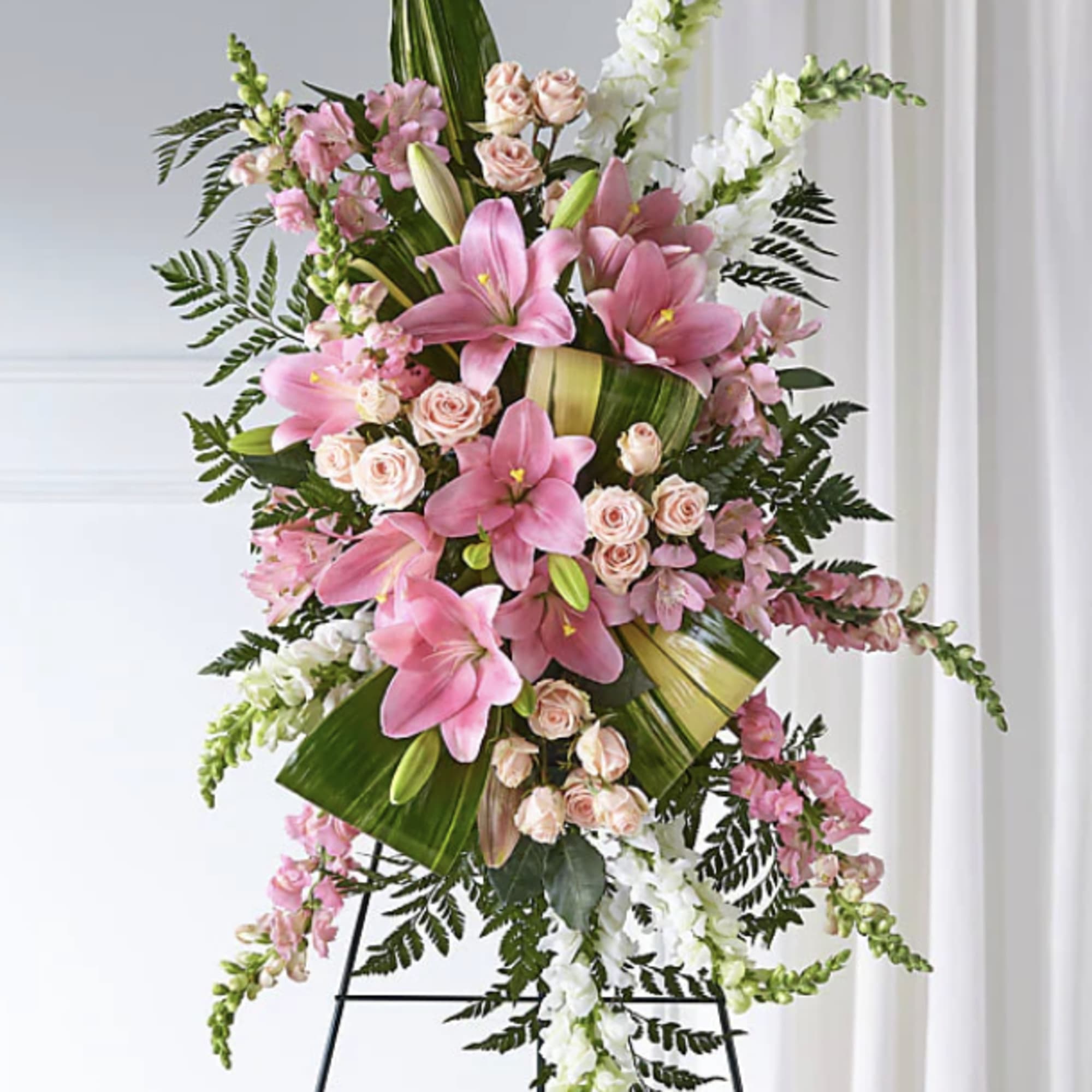Tall pink and white floral standing spray on an easel