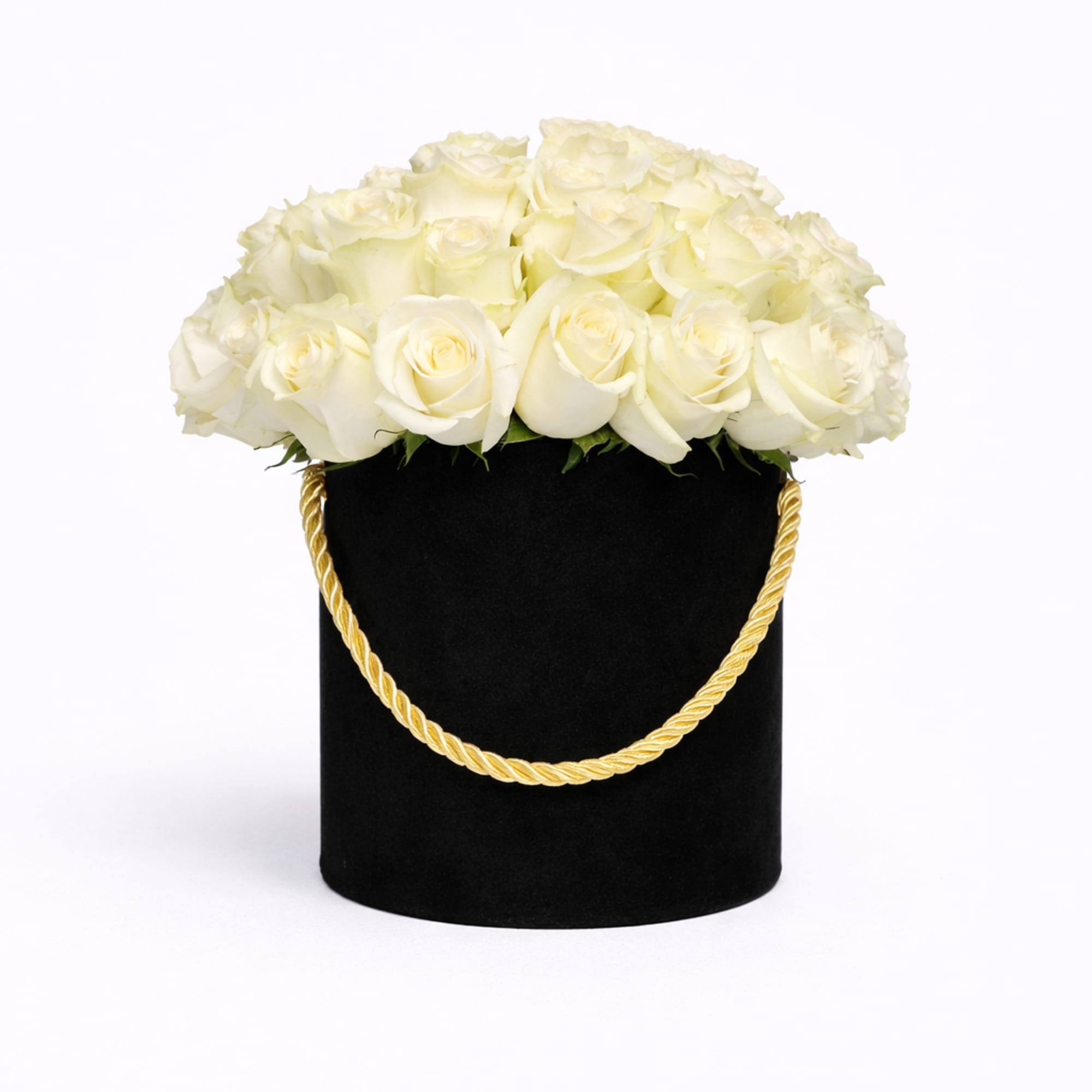 Round box of white roses in a black hatbox with a gold rope handle
