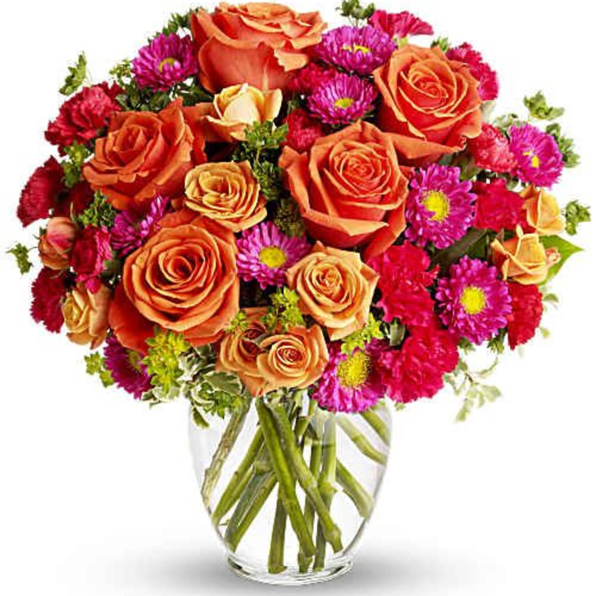 Orange roses and pink daisies in a clear glass vase
