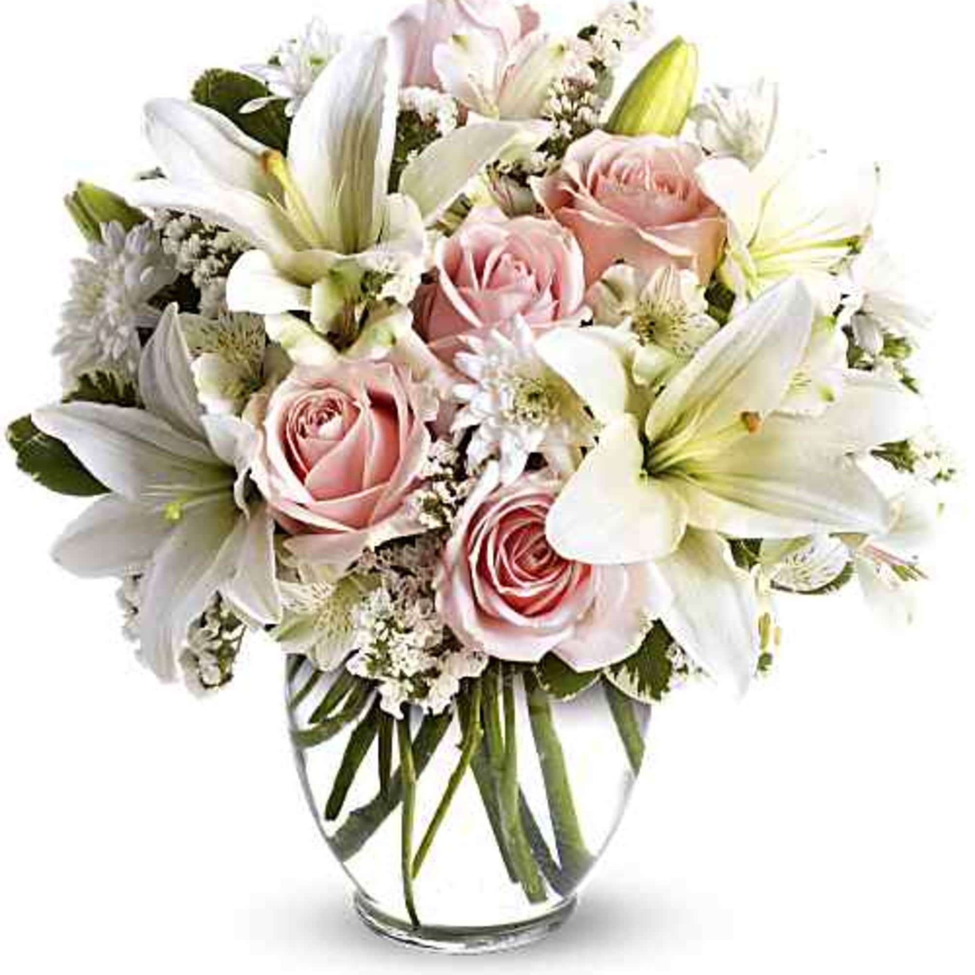 Pink roses and white lilies arranged in a clear glass vase