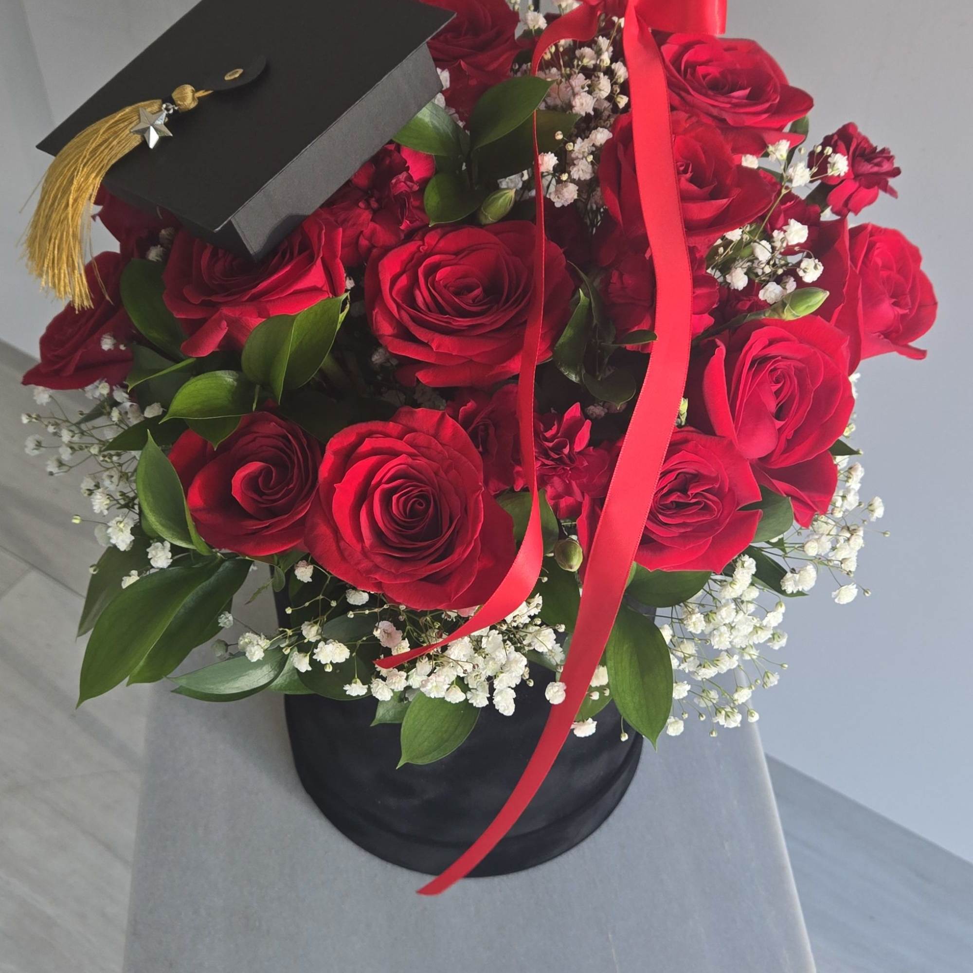 "Celebrate success in style with this elegant floral arrangement. Featuring lush red