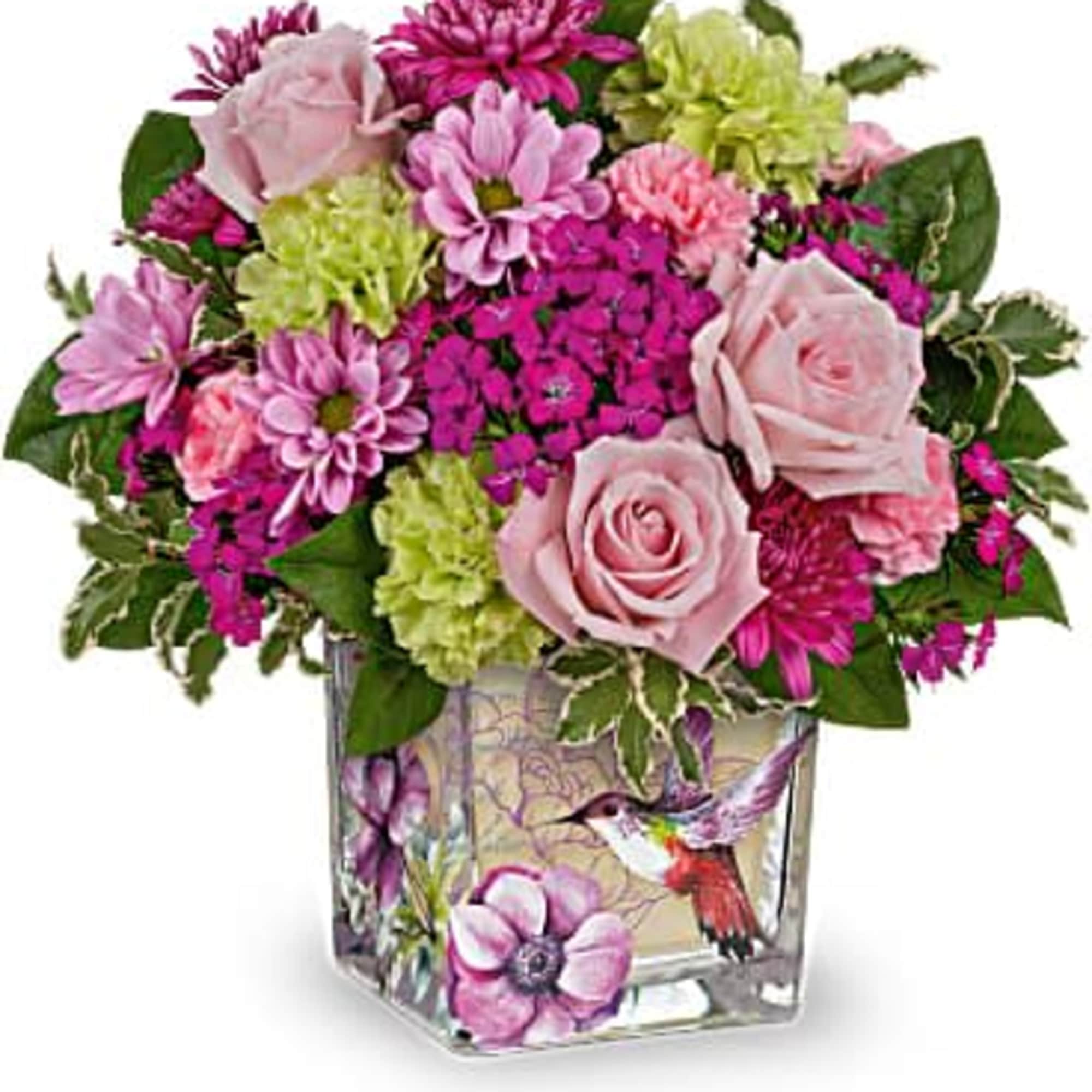 Pink and green flower arrangement in a square glass vase with a hummingbird design