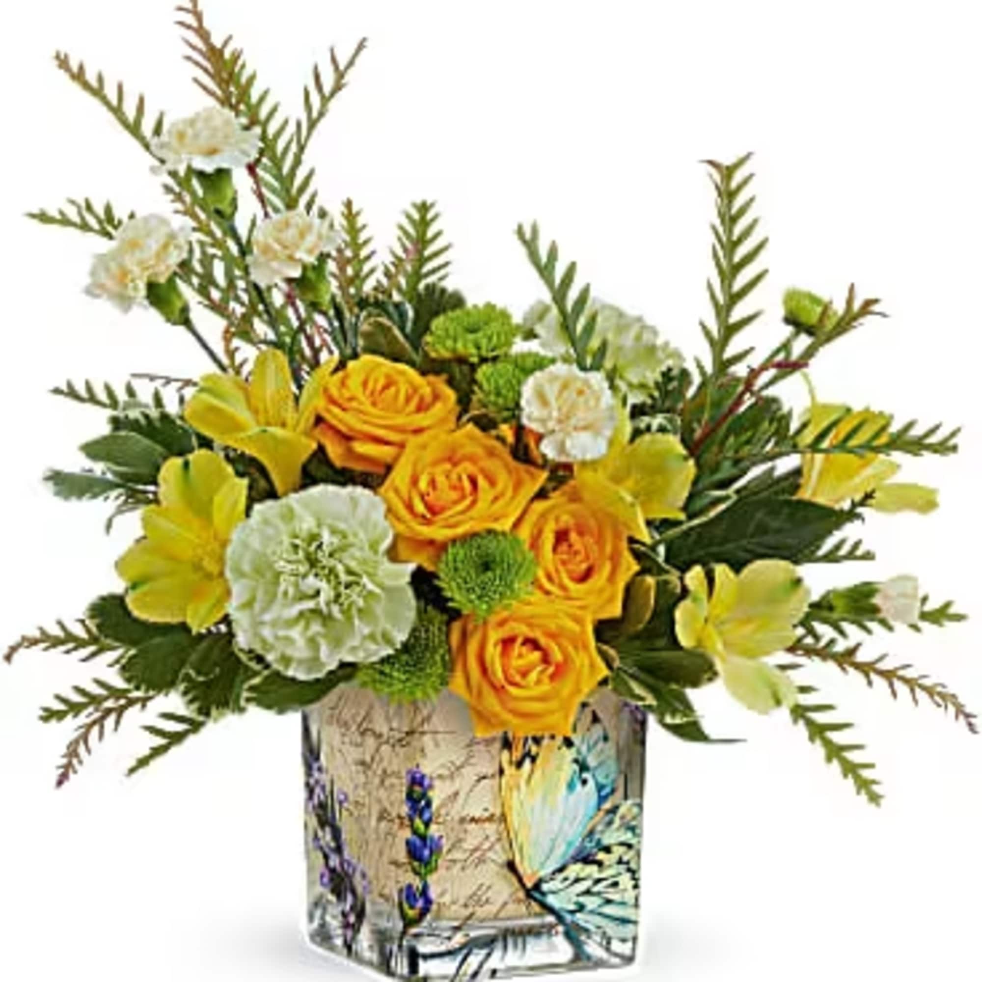 Yellow roses and carnations in a decorative glass vase