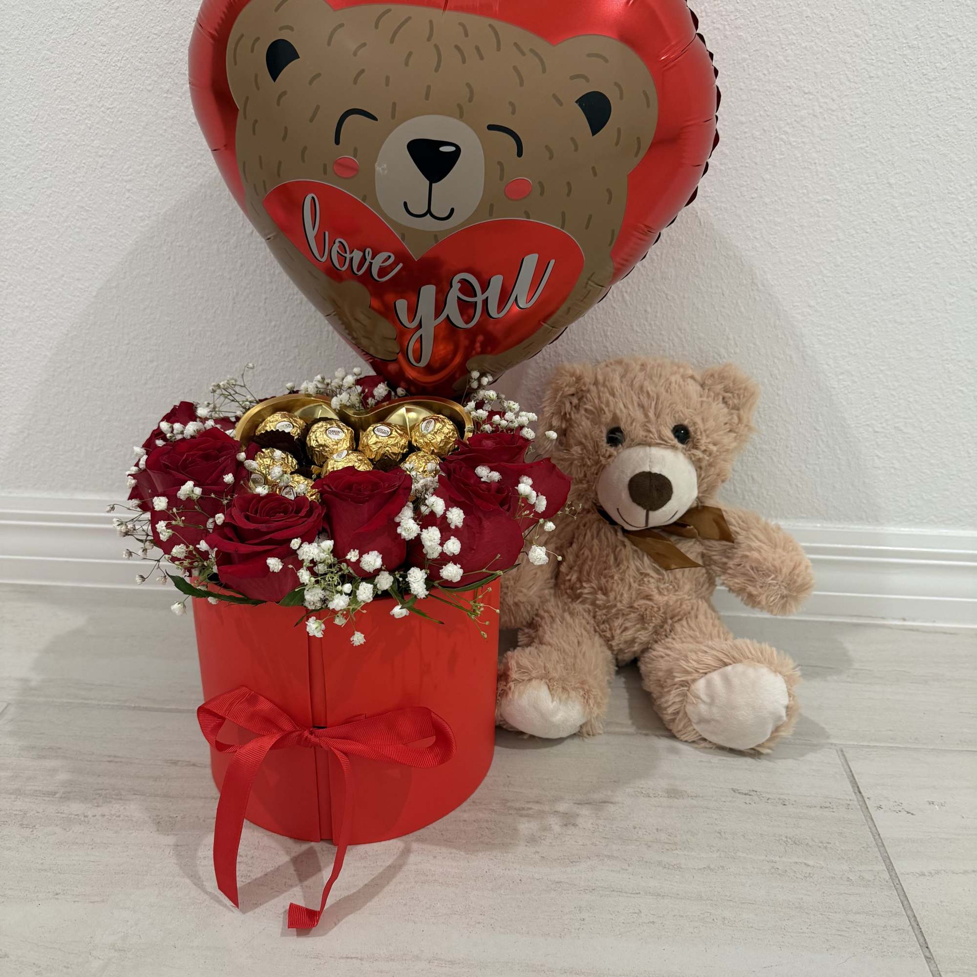 An elegant red round surprise box that opens to reveal space for