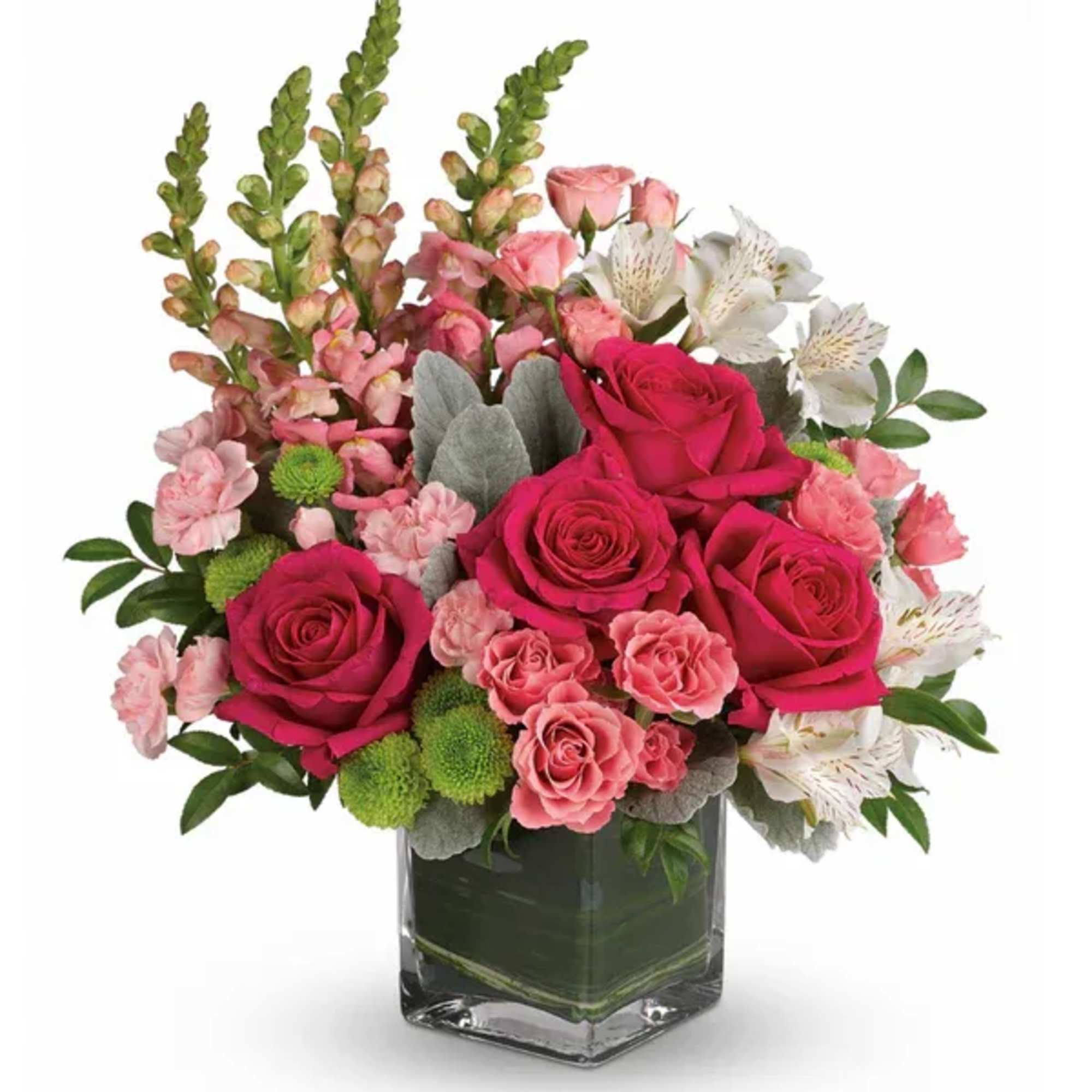 Pink roses and mixed flowers arranged in a clear glass vase