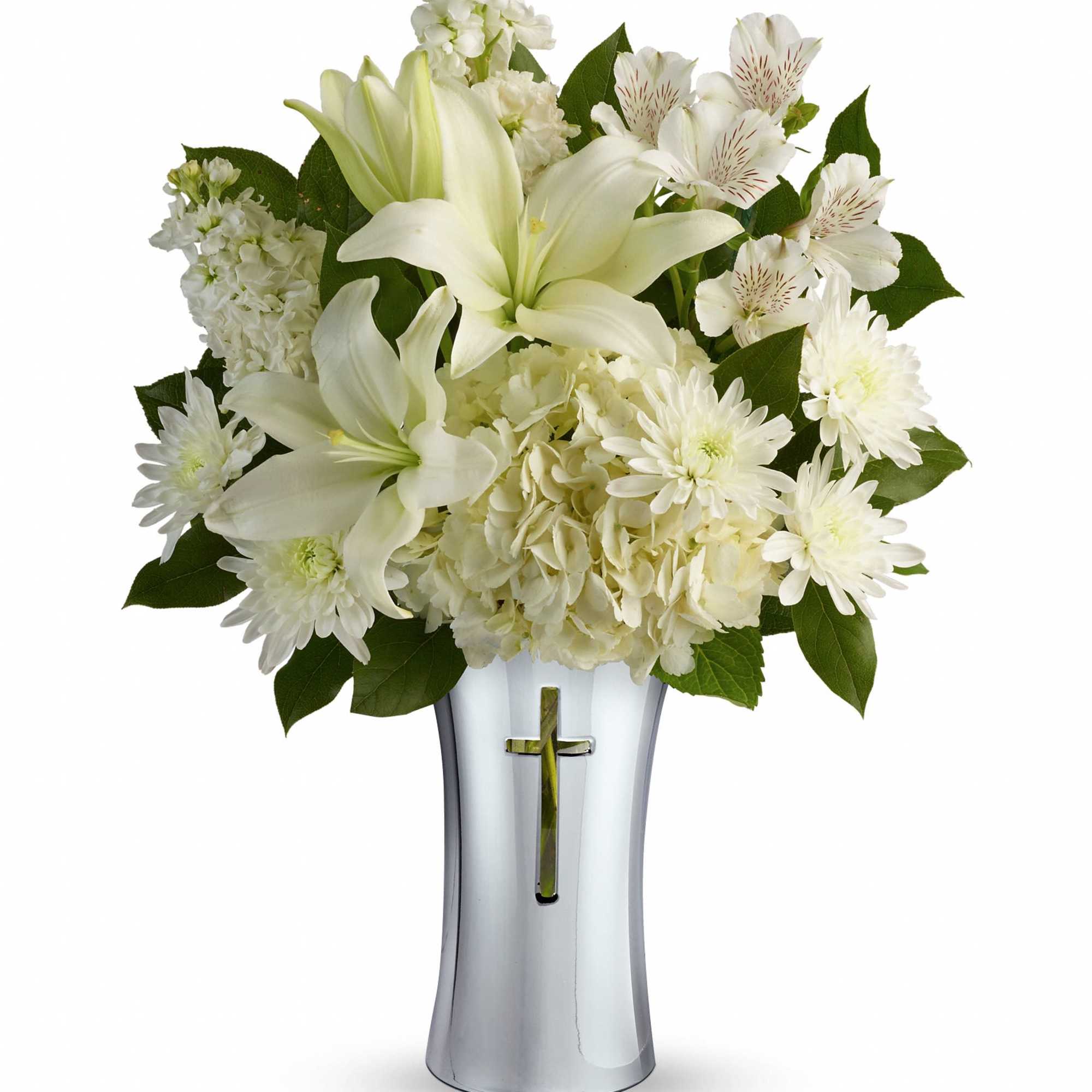 White lilies and mixed white flowers in a silver vase with a cross