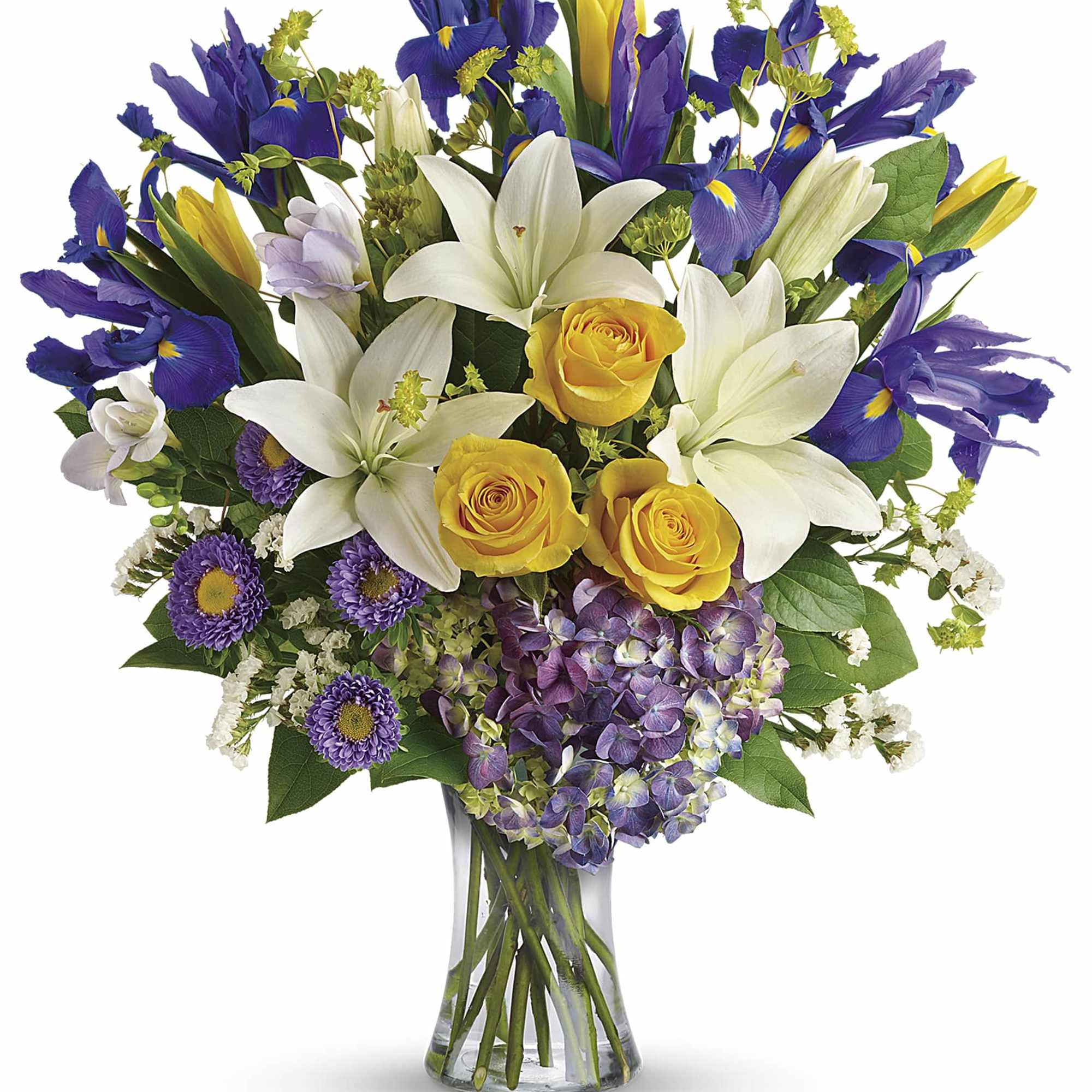 Bouquet of white lilies, yellow roses, and purple irises in a glass vase