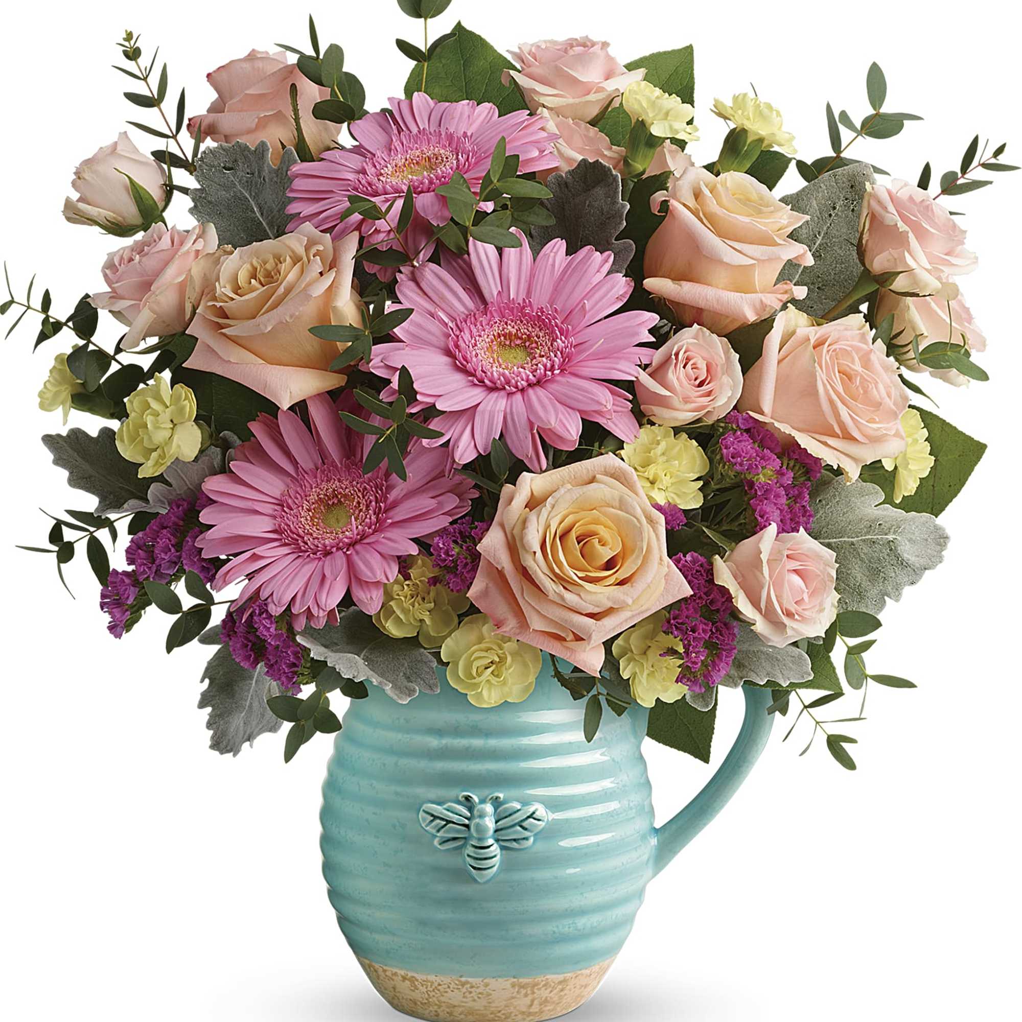 Pink and peach flowers arranged in a turquoise pitcher vase