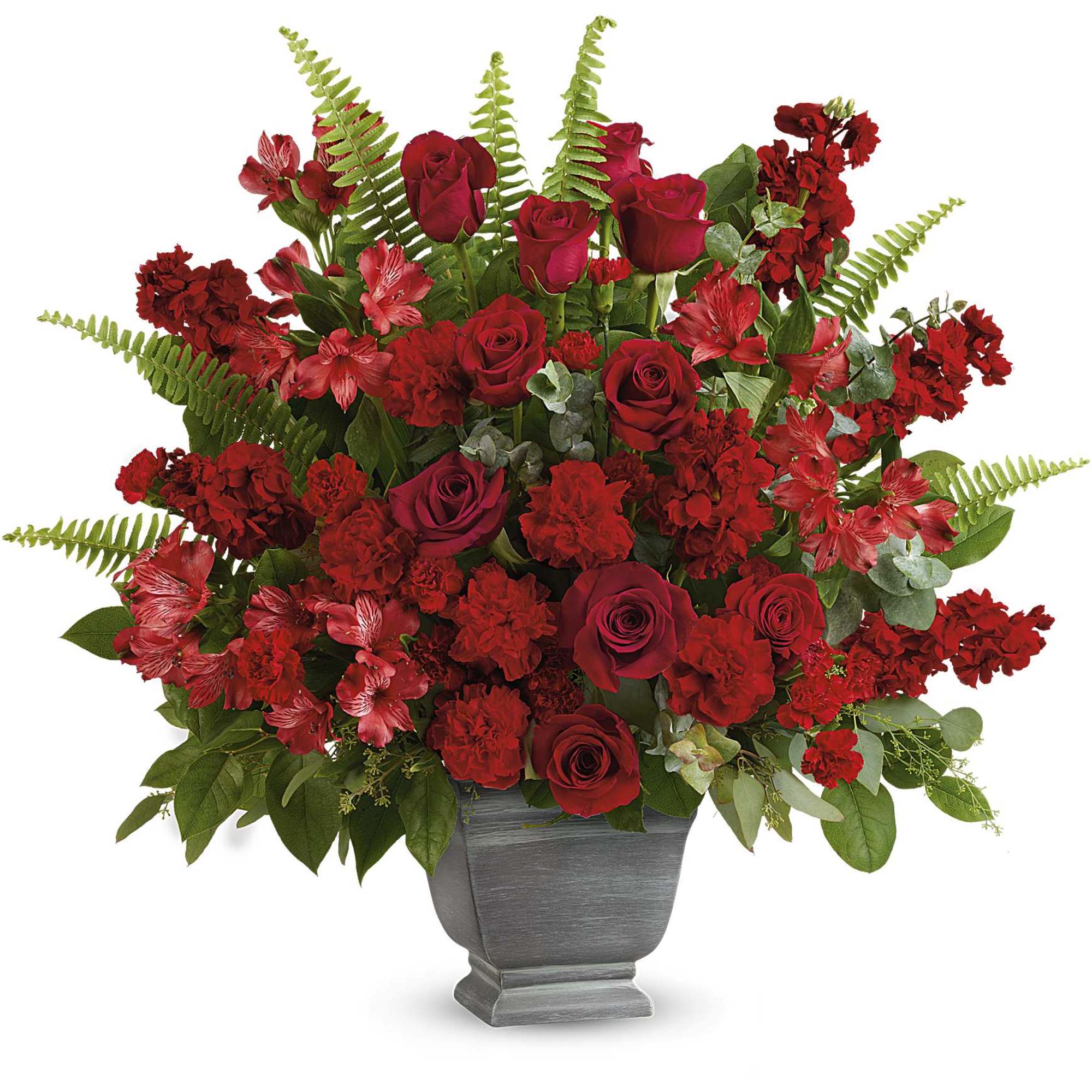 Red roses and carnations arranged in a gray urn vase