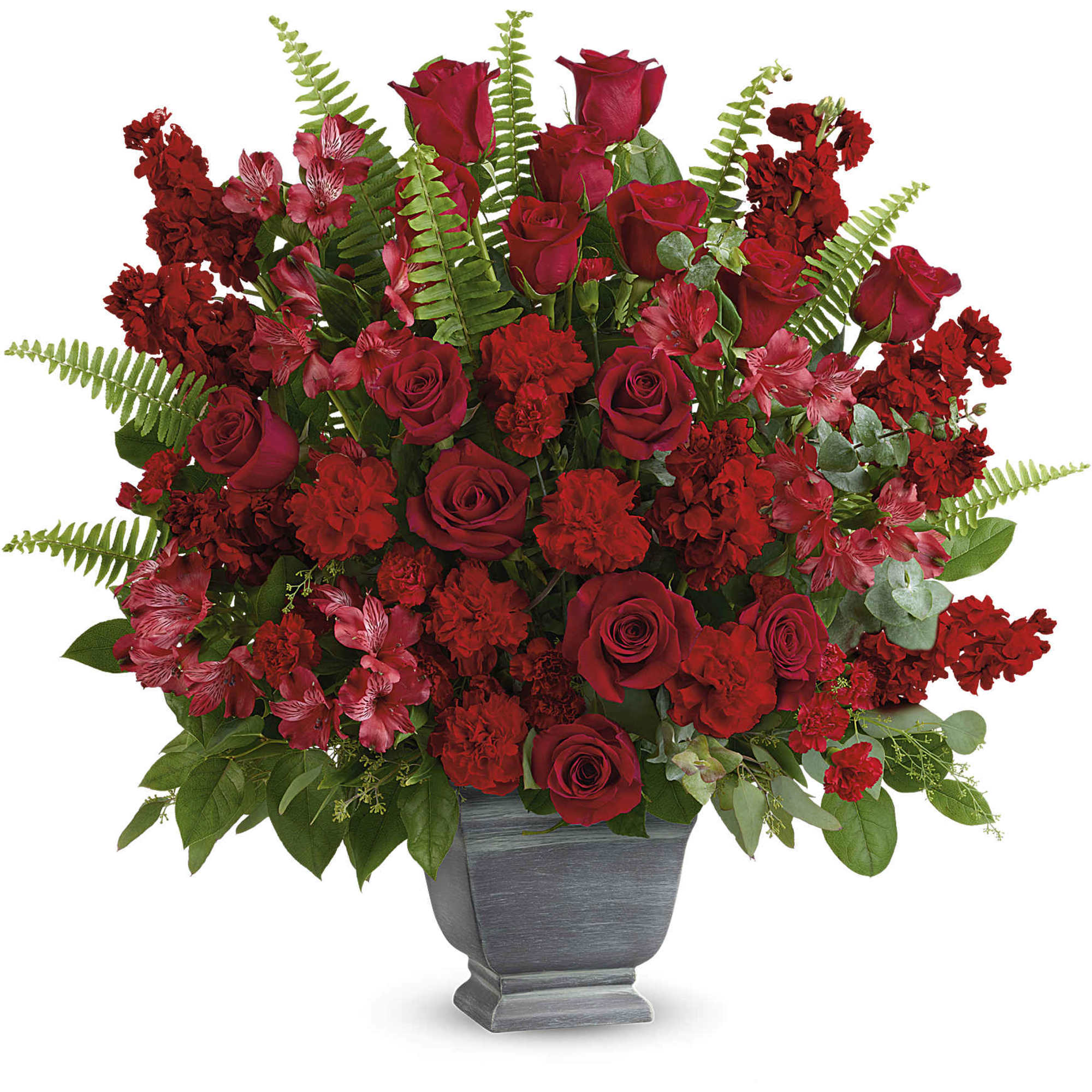 Red roses and carnations arranged in a gray urn vase