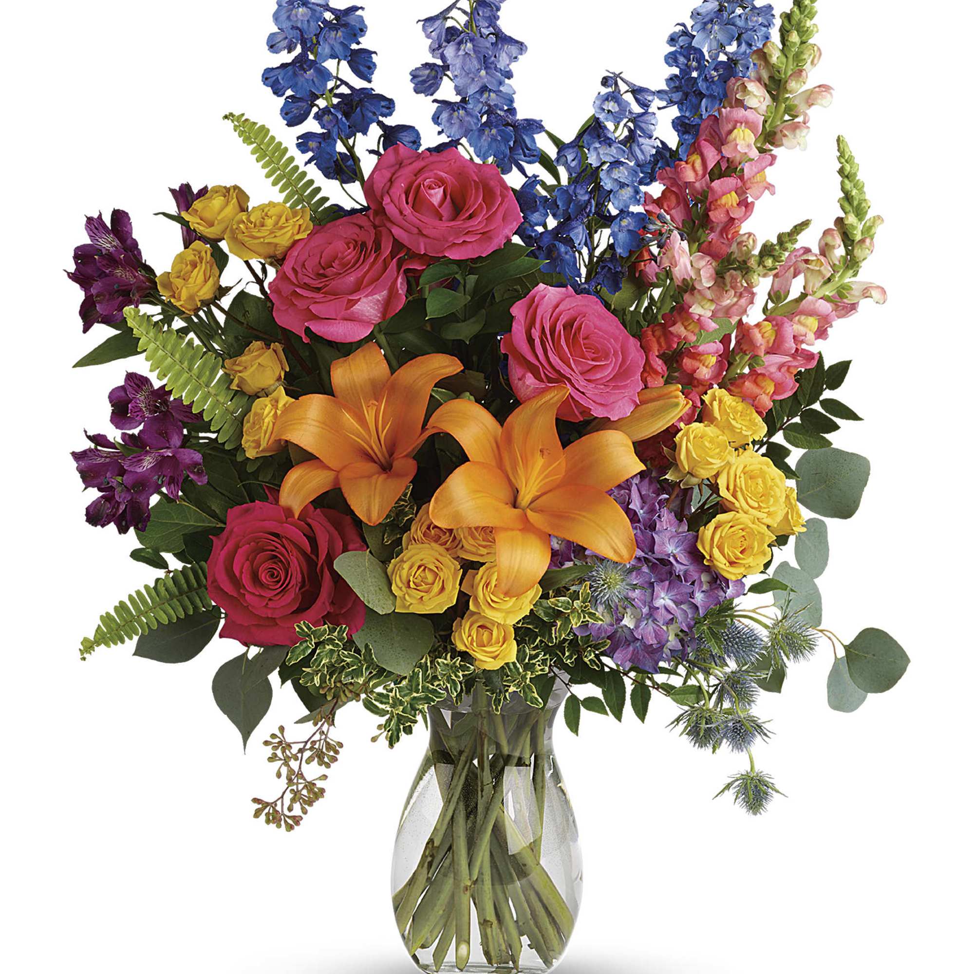 Colorful bouquet of roses, lilies, and mixed blooms in a clear glass vase
