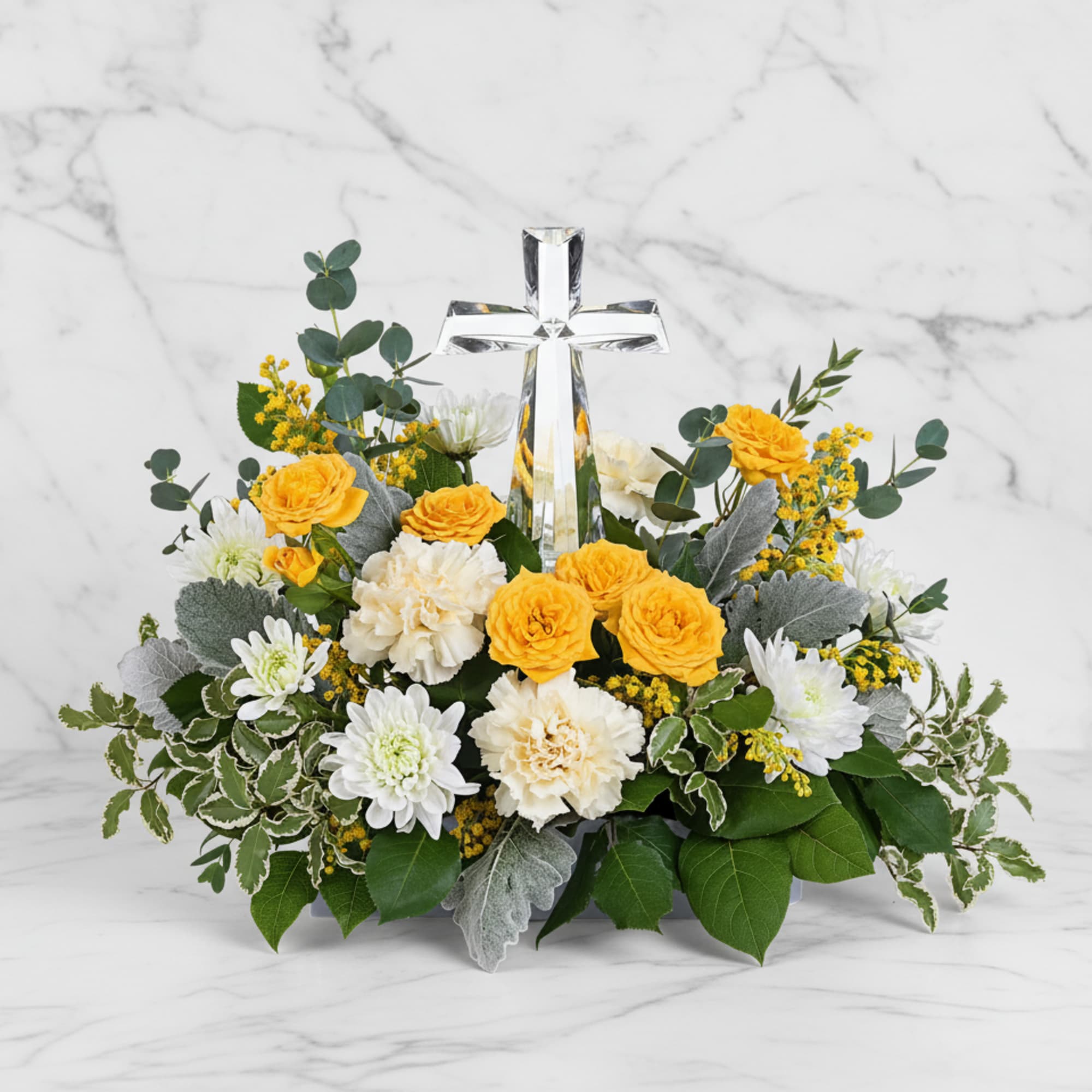 Encircling a beautiful crystal cross keepsake, this sunny bouquet of roses and
