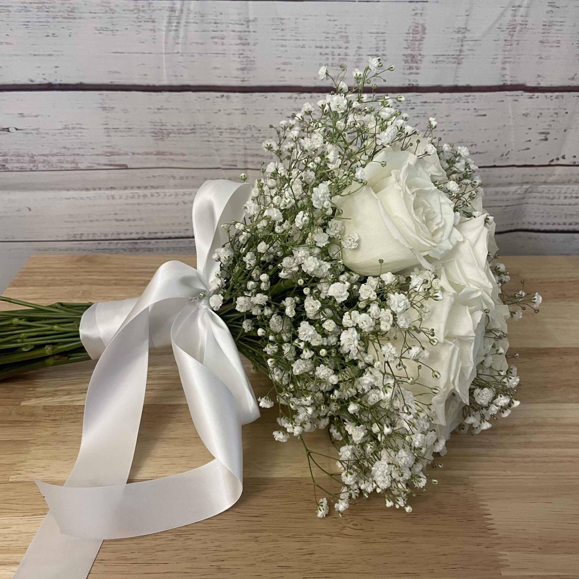 12 white roses with gyp filler 