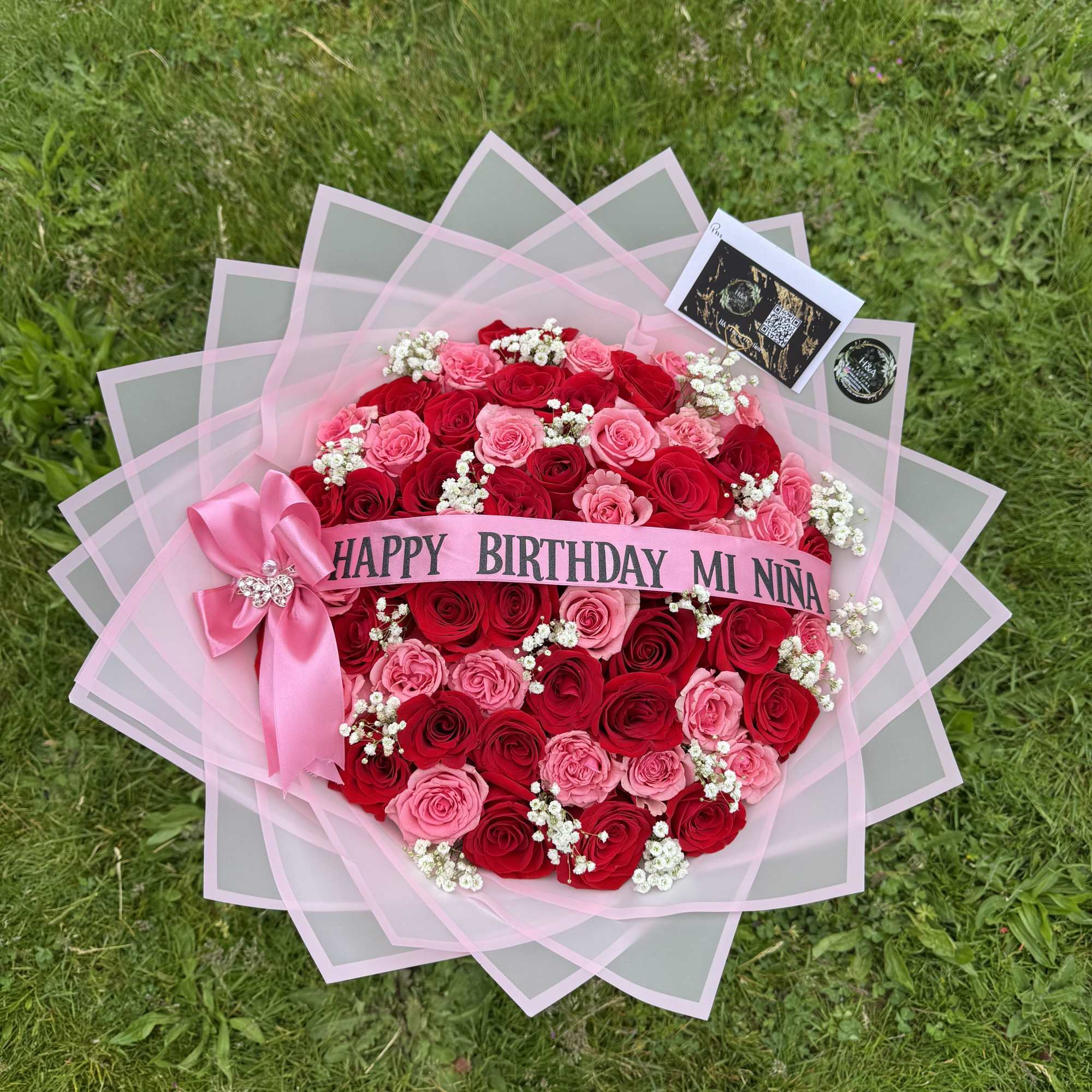 Pink and red rose bouquet with a birthday ribbon and bow