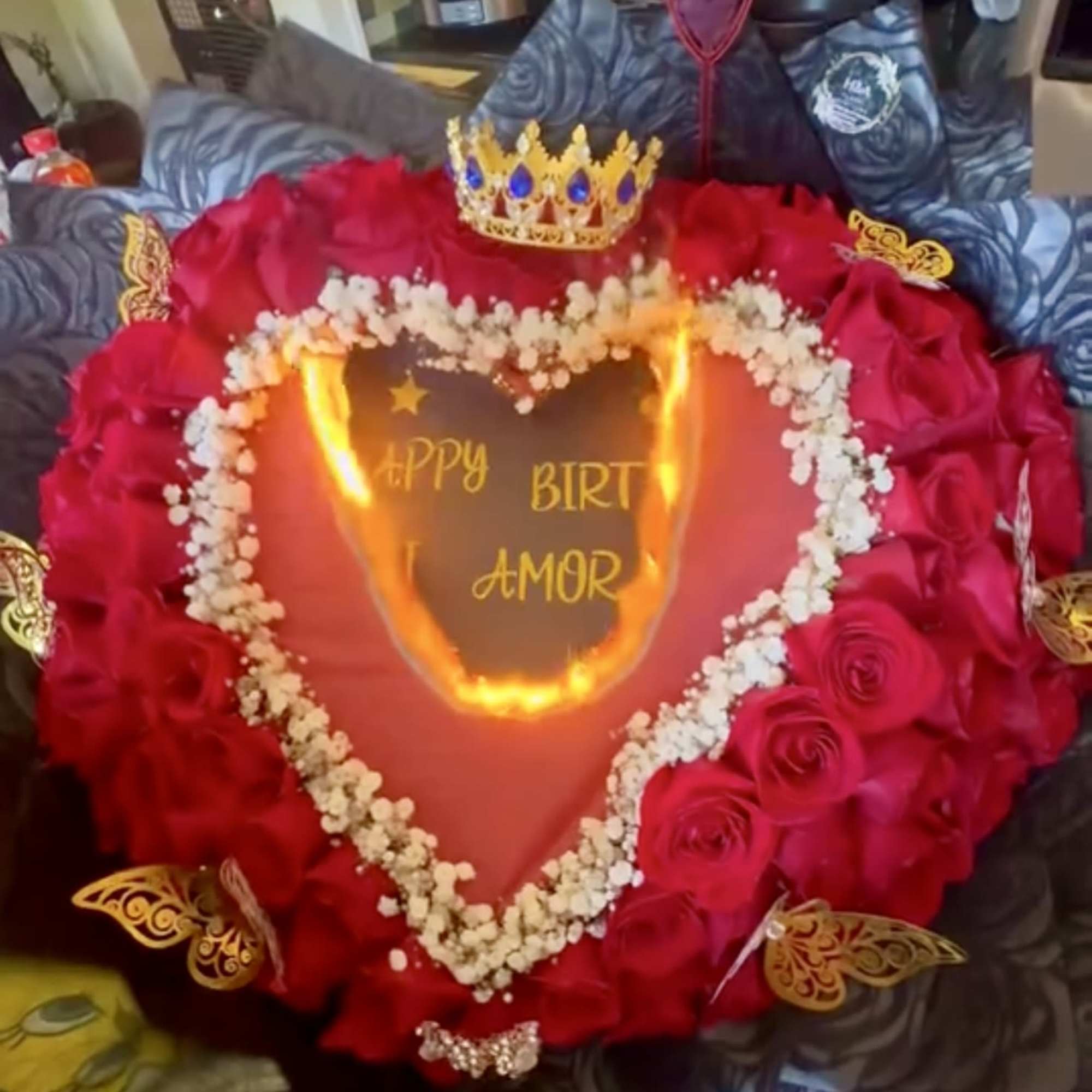 Heart-shaped rose arrangement with a crown topper and birthday message