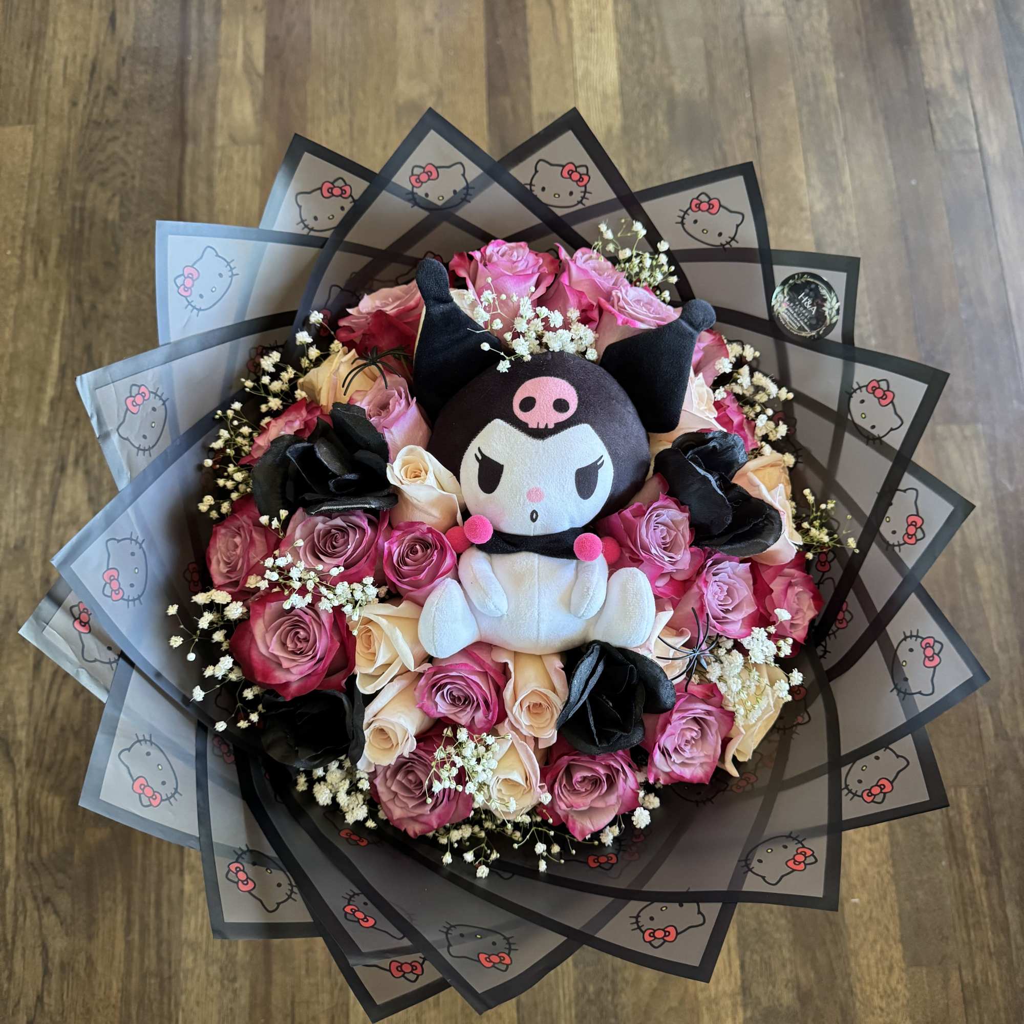 Bouquet of pink and cream roses with a Kuromi plush centerpiece
