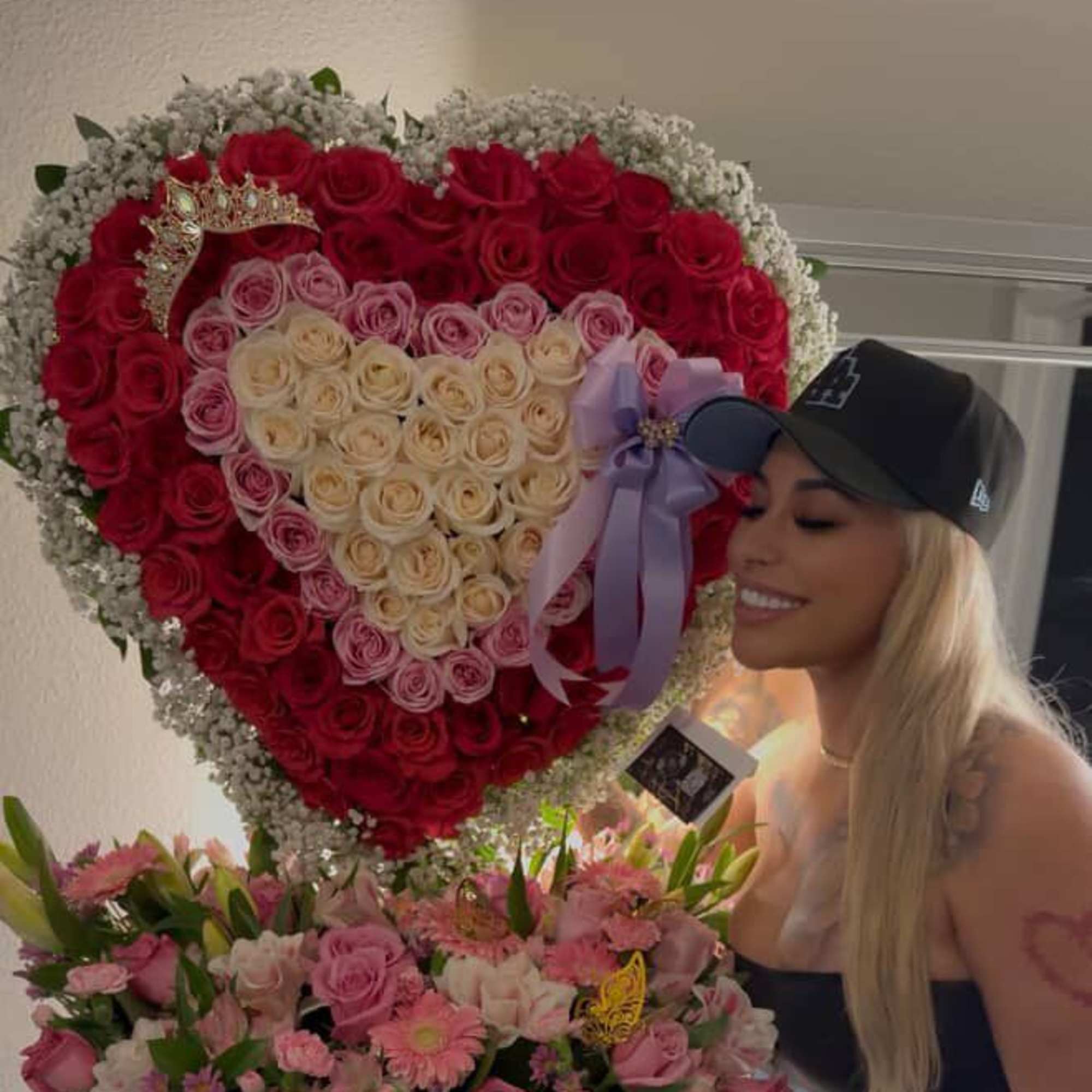 Heart-shaped rose arrangement with a lavender bow and a mixed pink bouquet in a box