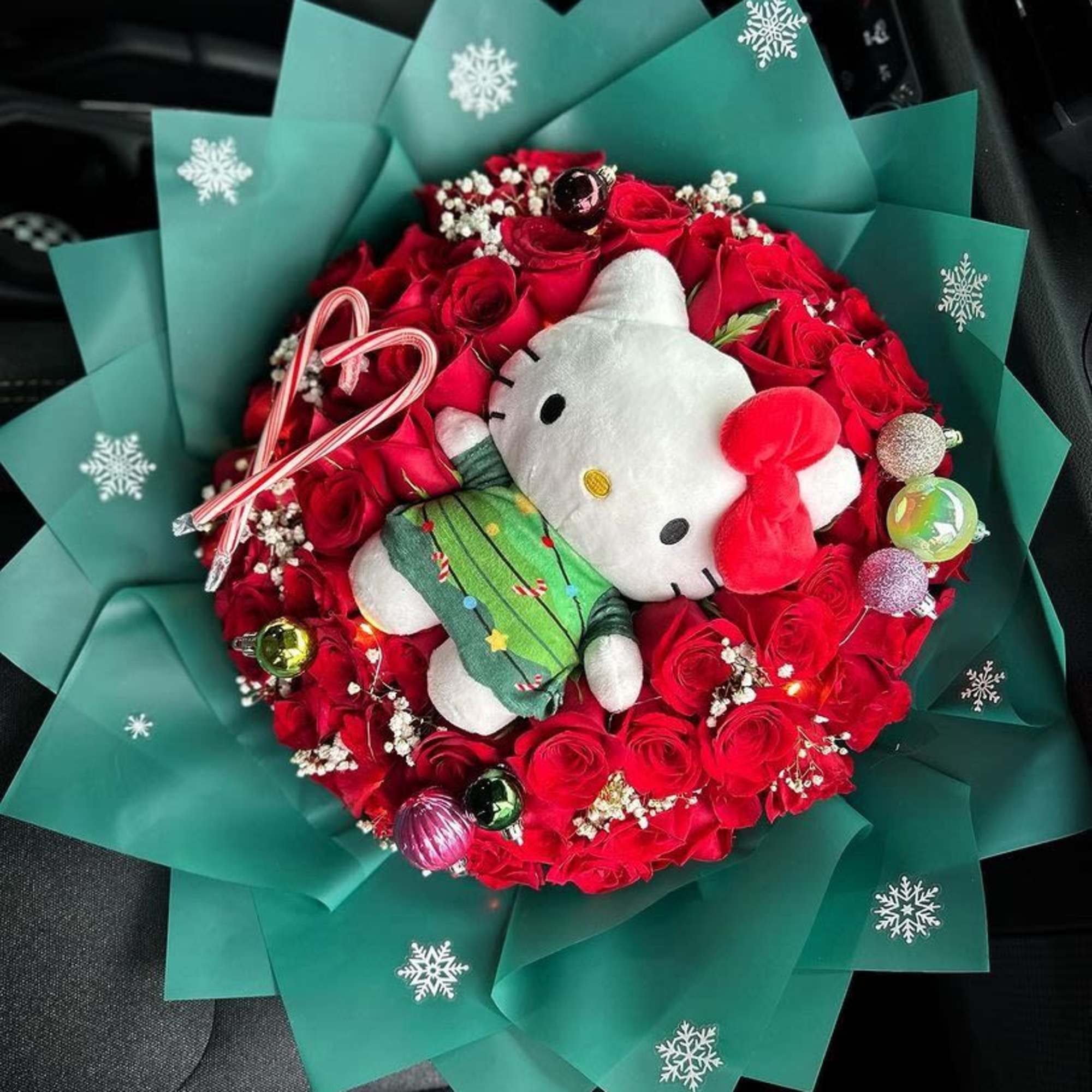 Red rose bouquet with a Hello Kitty plush and teal wrapping