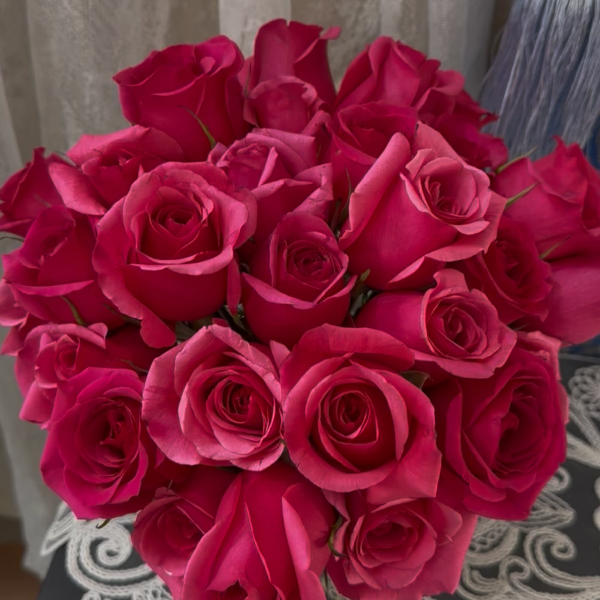 Bouquet of hot pink roses arranged in a rounded cluster