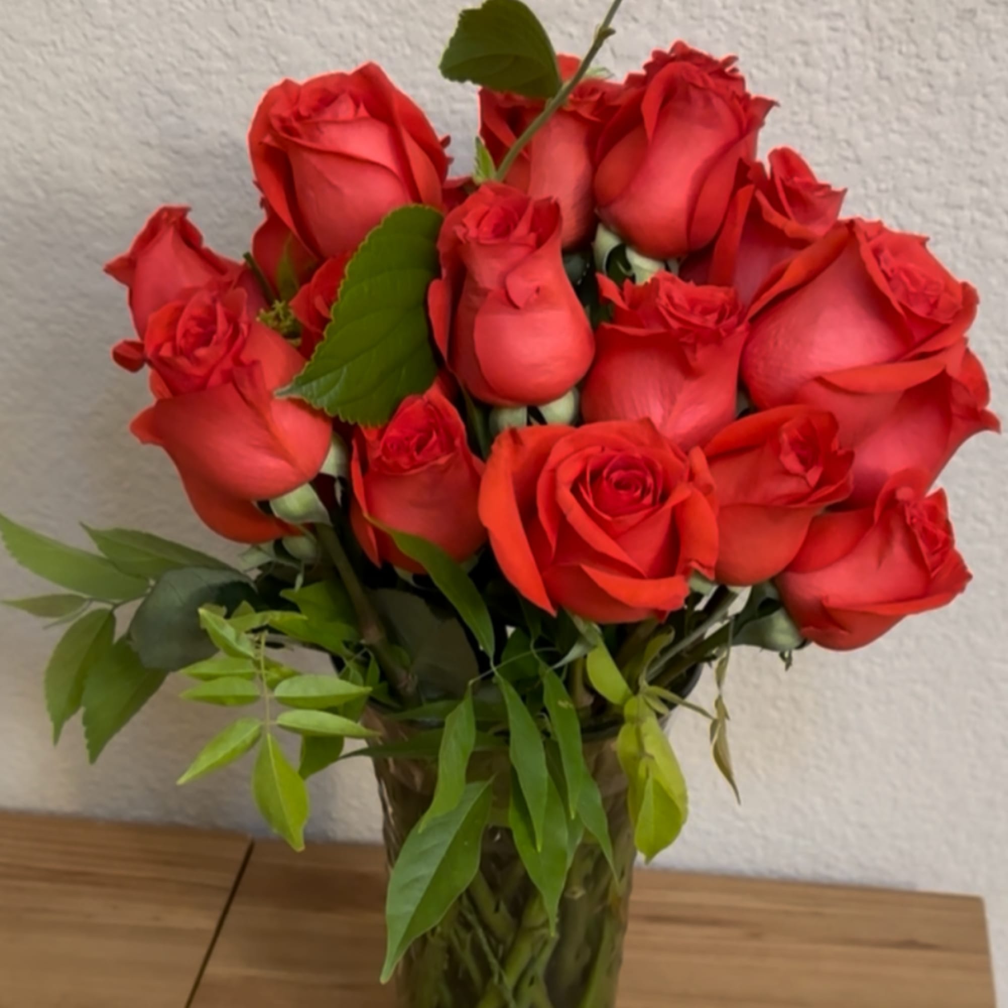 A gathering of premium radiant orange roses, deep as a lover&rsquo;s gaze