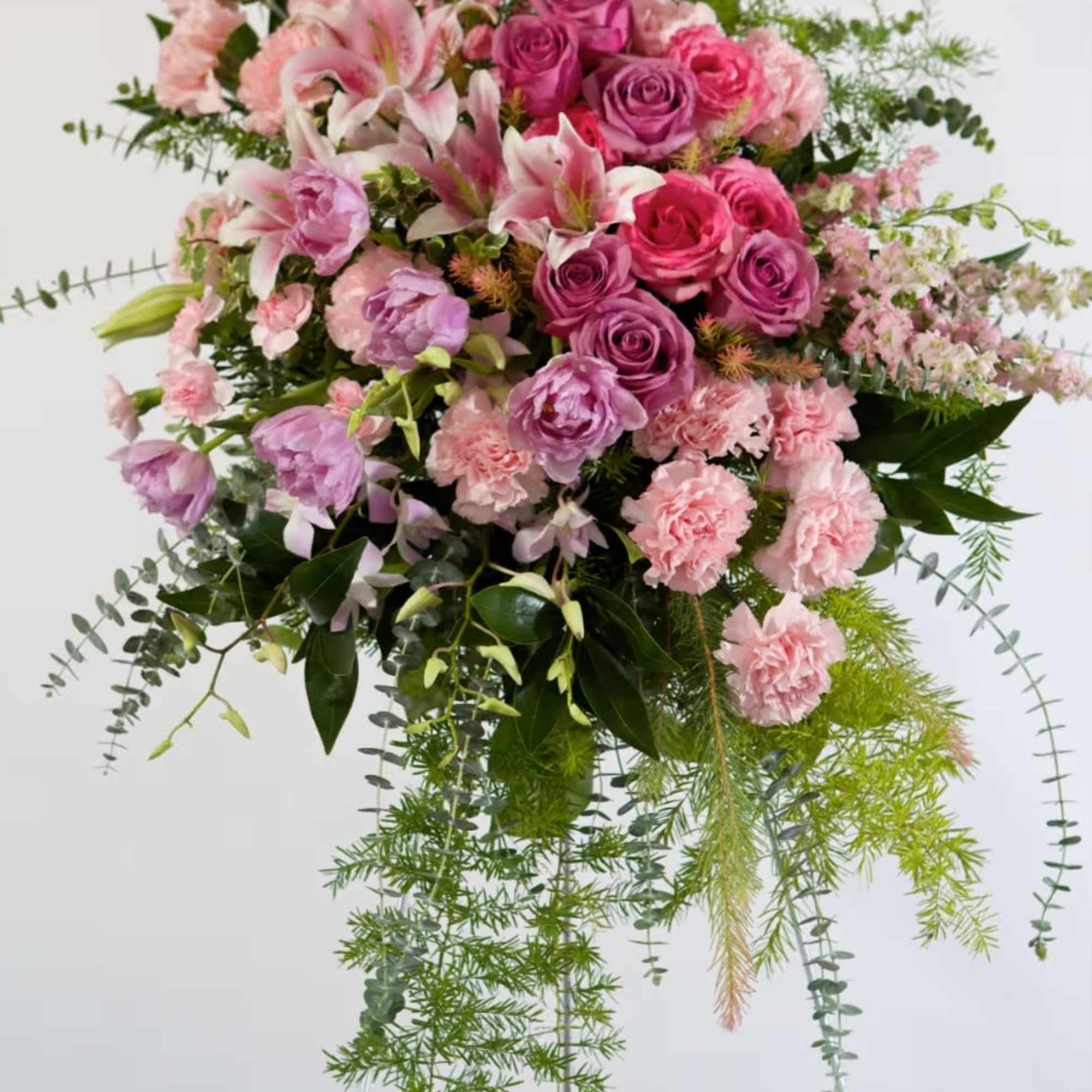 Large pink and lavender floral arrangement on a stand