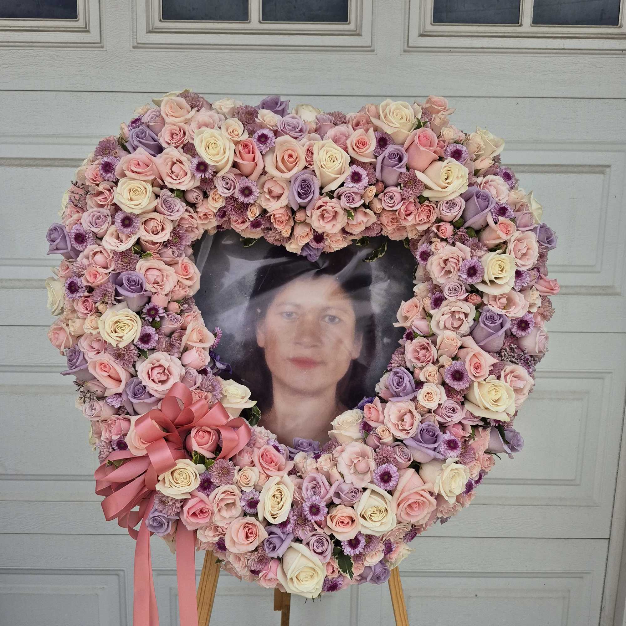 Heart-shaped floral wreath with a portrait in the center
