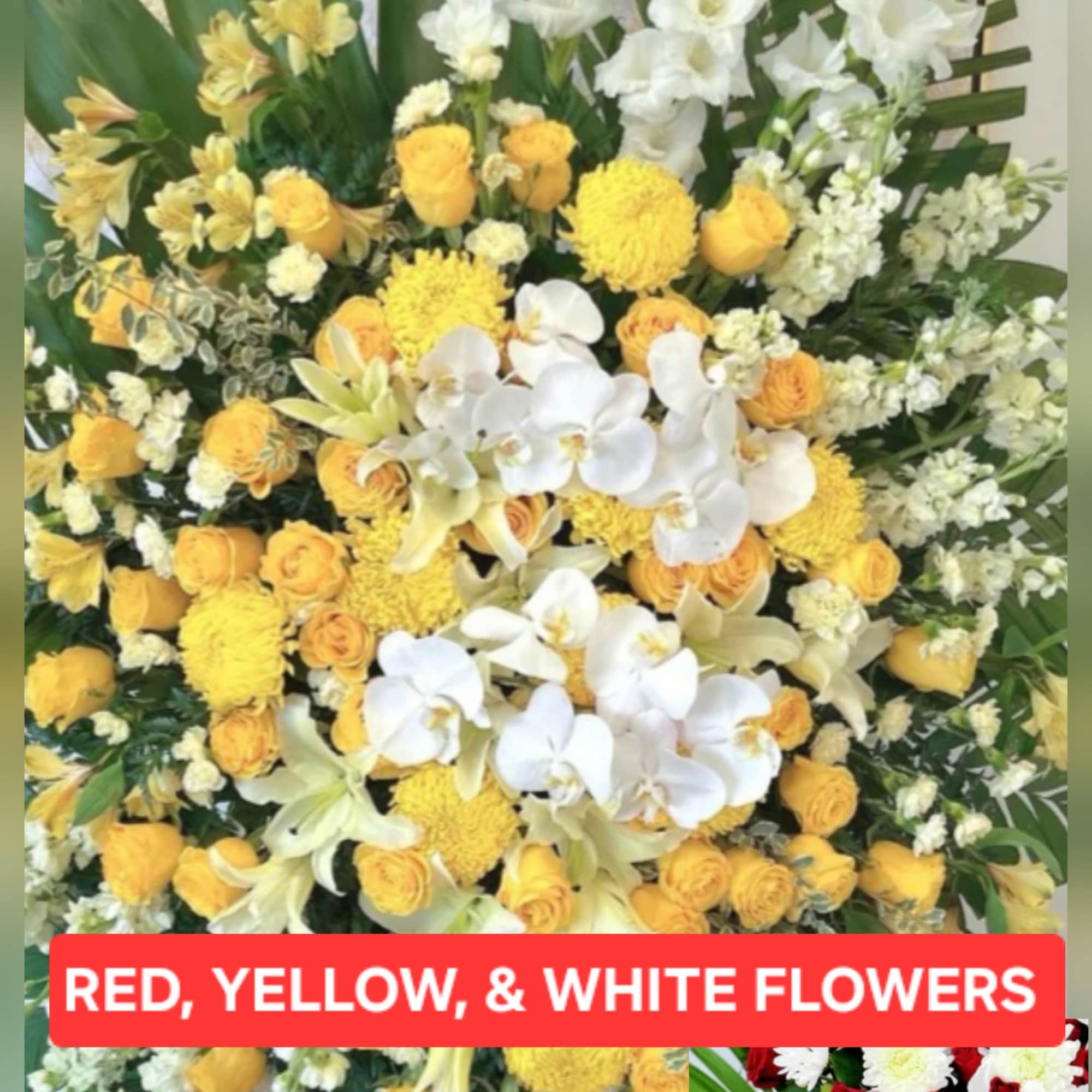 A bright, ceremonial standing sympathy spray designed to honor a loved one
