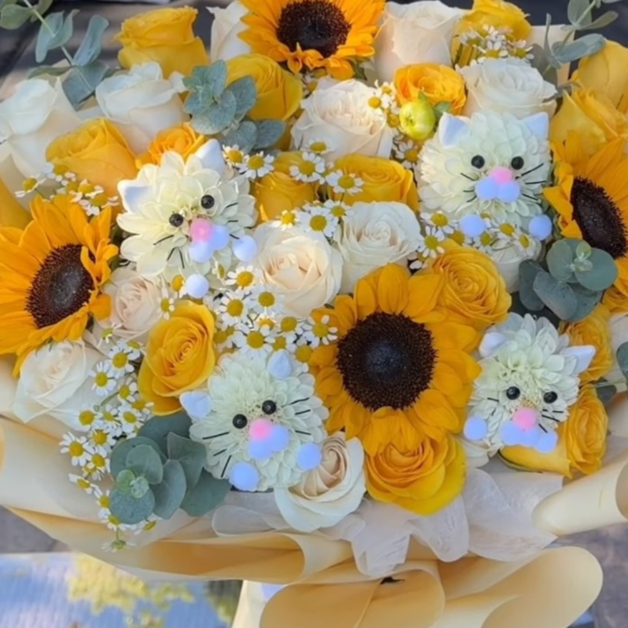Bouquet of yellow and white roses with sunflowers and small daisy flowers