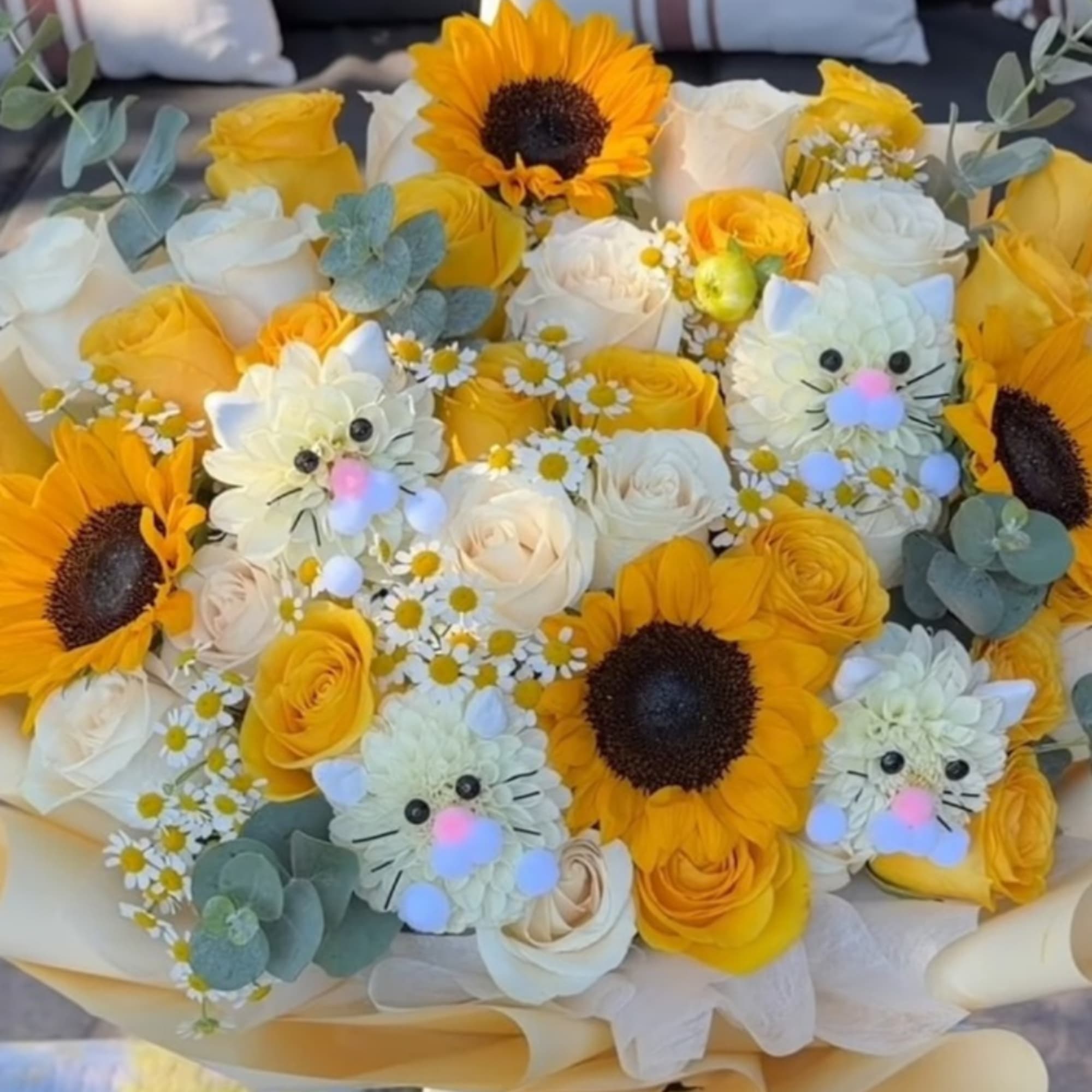 Bouquet of yellow and white roses with sunflowers and small daisy flowers