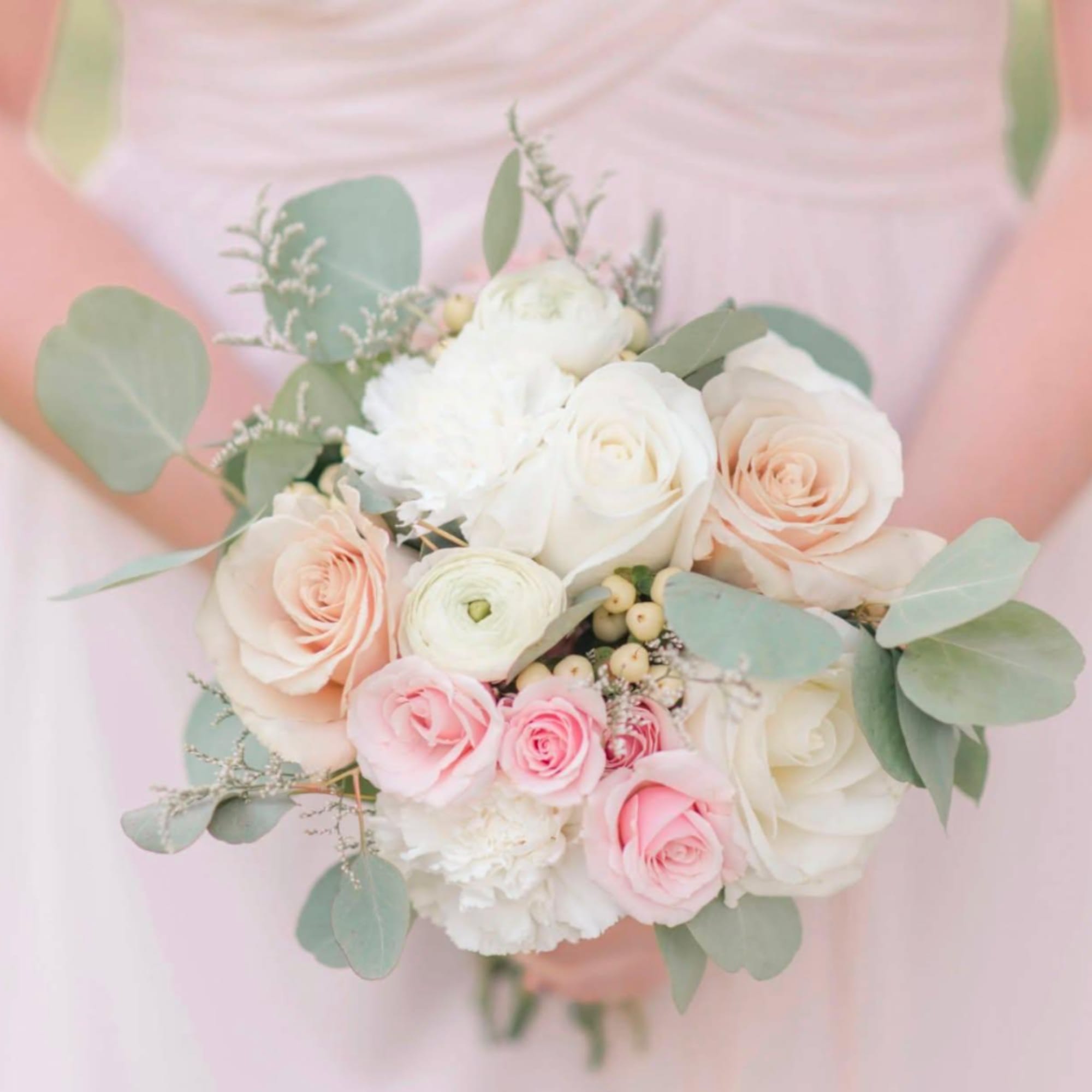 Pastel bridal bouquet with white, blush, and pink roses