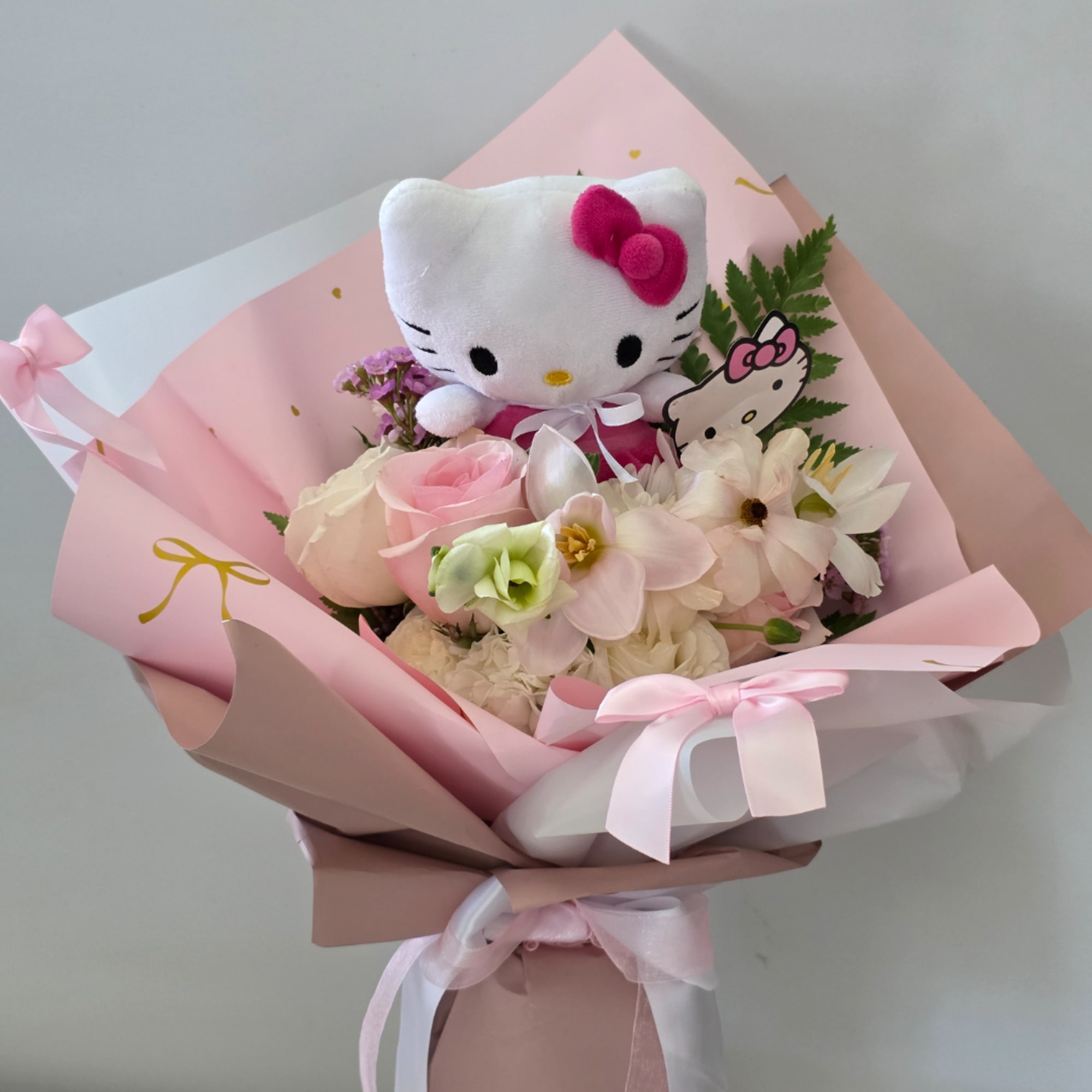 Pink bouquet with a Hello Kitty plush and pastel flowers