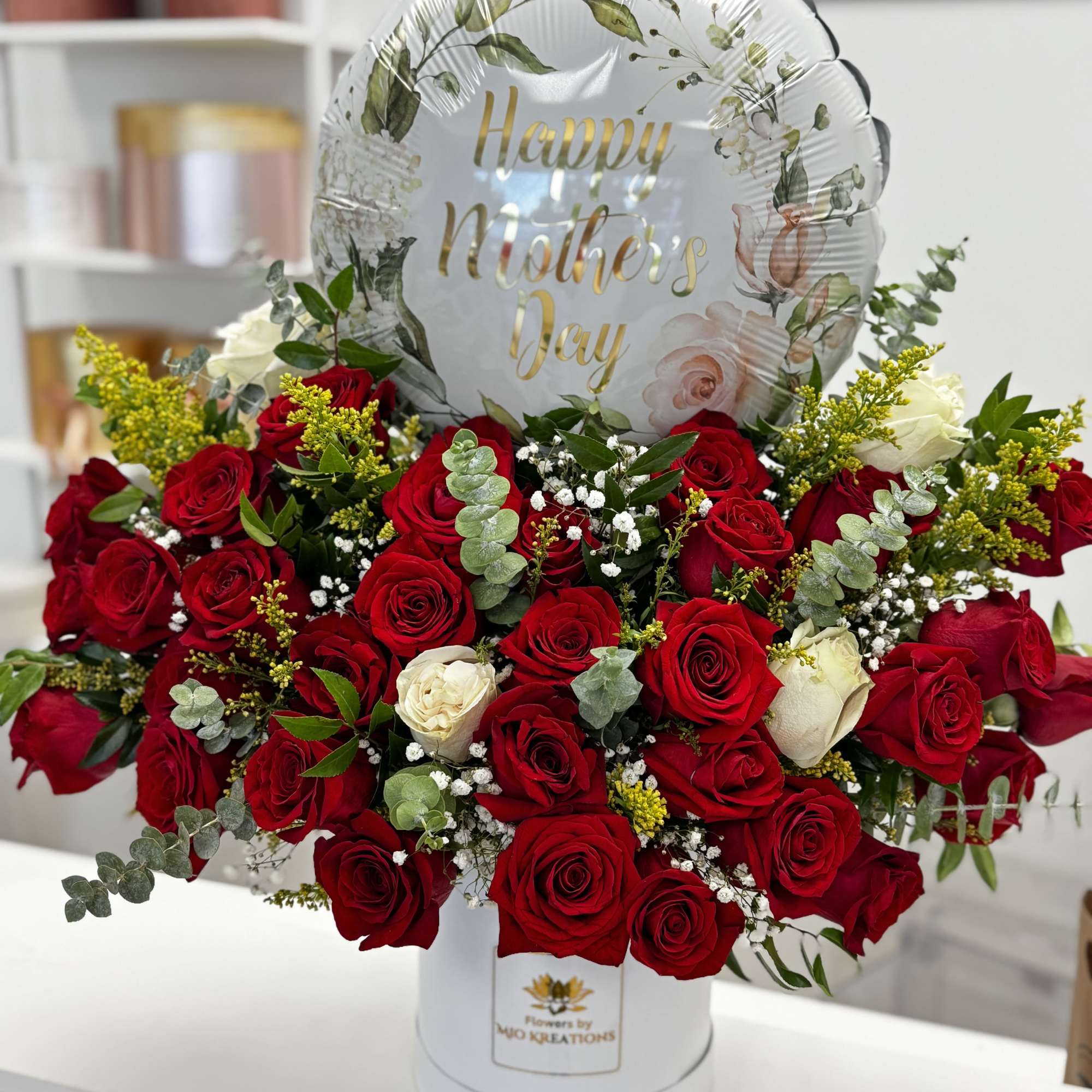 Red rose bouquet in a white hatbox with a "Happy Mother's Day" balloon