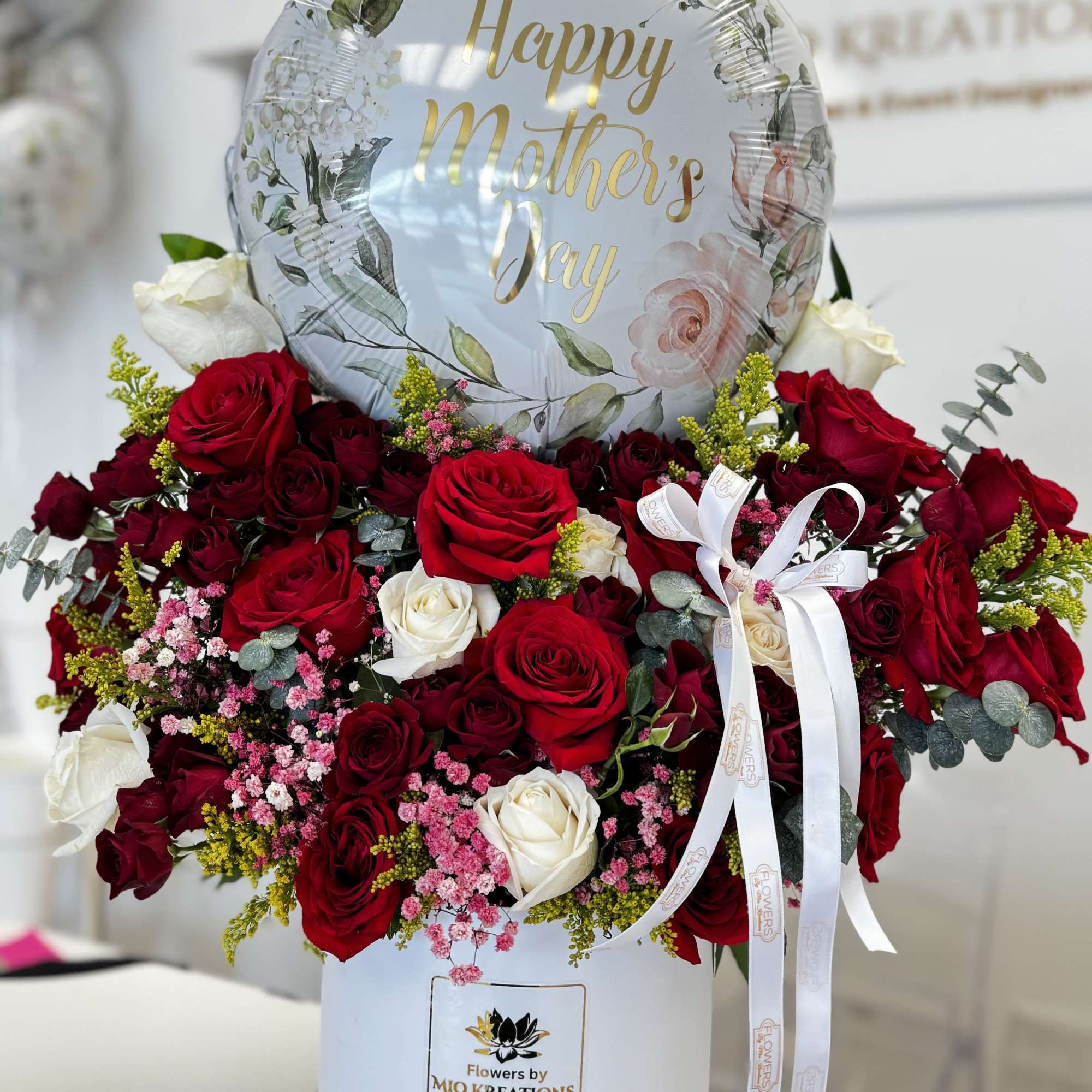 Red and white rose arrangement with a Mother's Day balloon in a white hat box