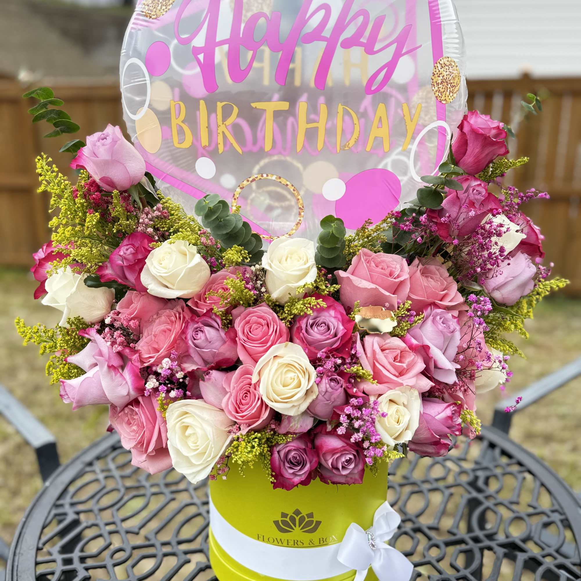 Pink and white rose arrangement with a Happy Birthday balloon