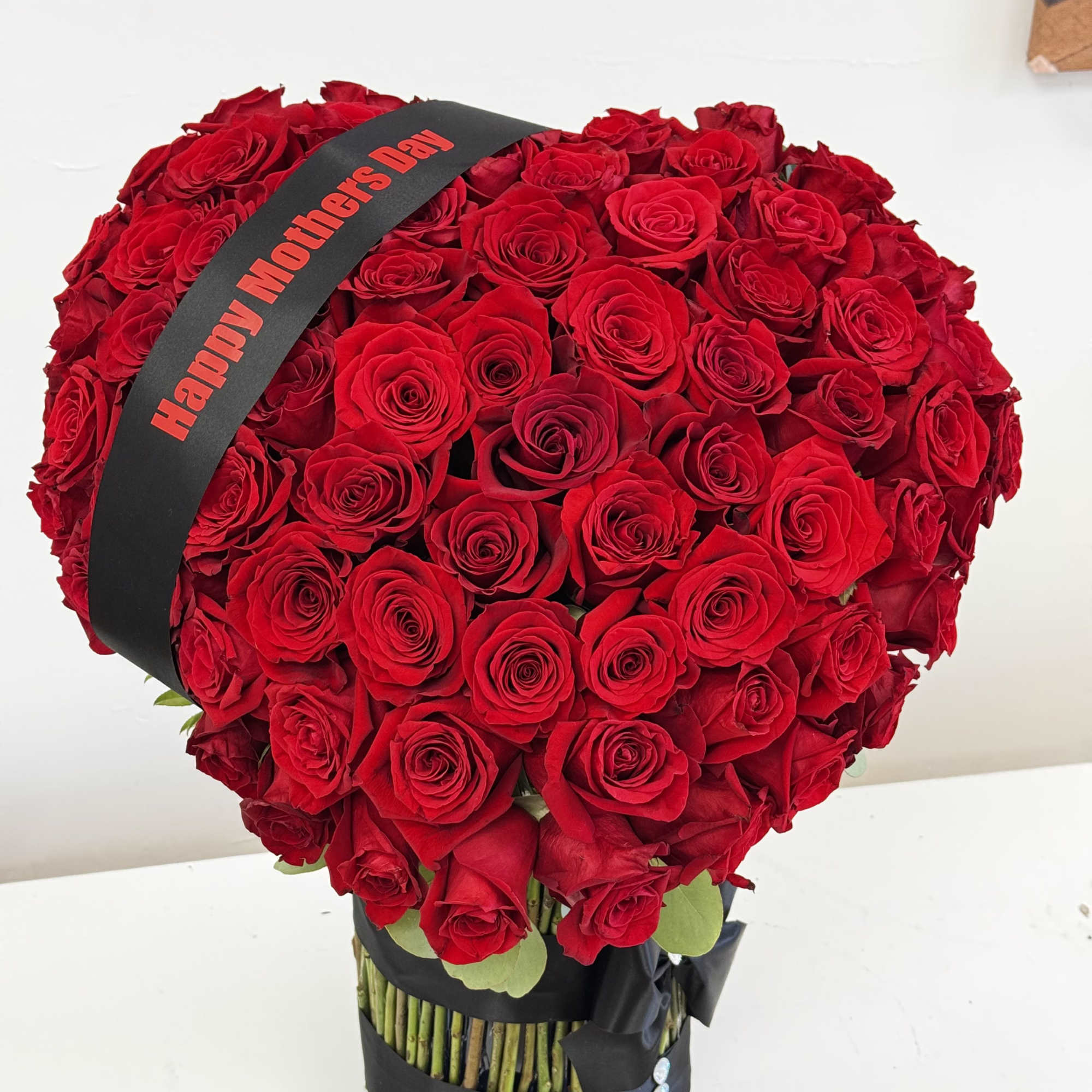 Large bouquet of red roses with a Mother's Day ribbon