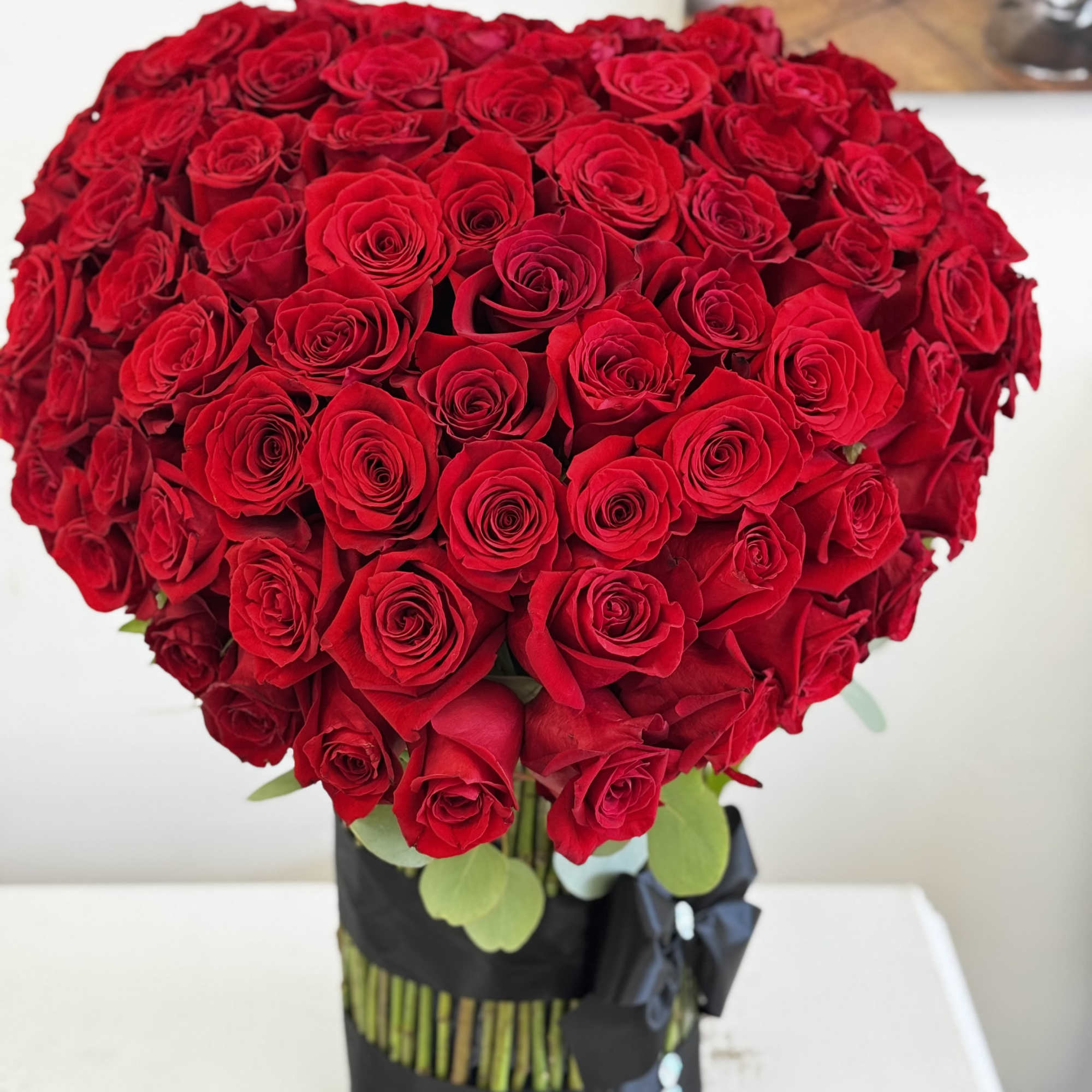 Large bouquet of red roses in a black wrap, photo 6 of 6