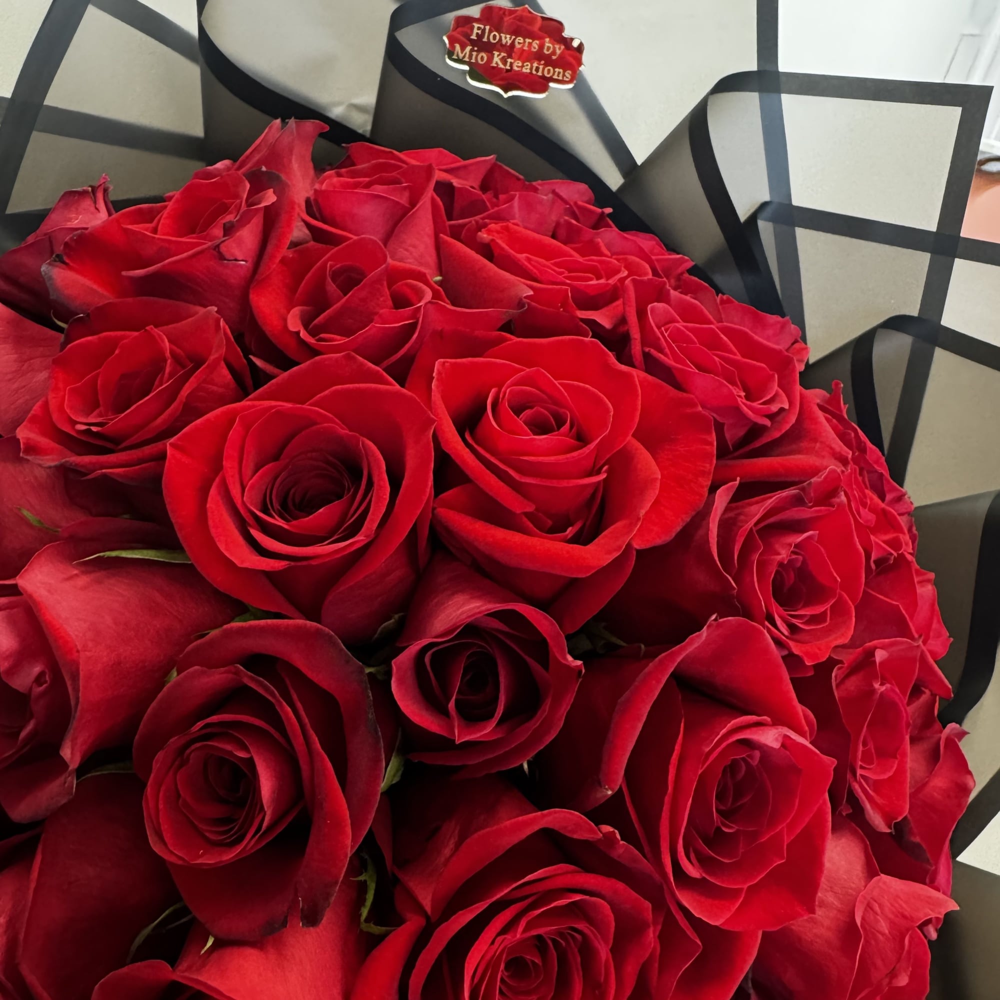 Bouquet of red roses wrapped in black paper